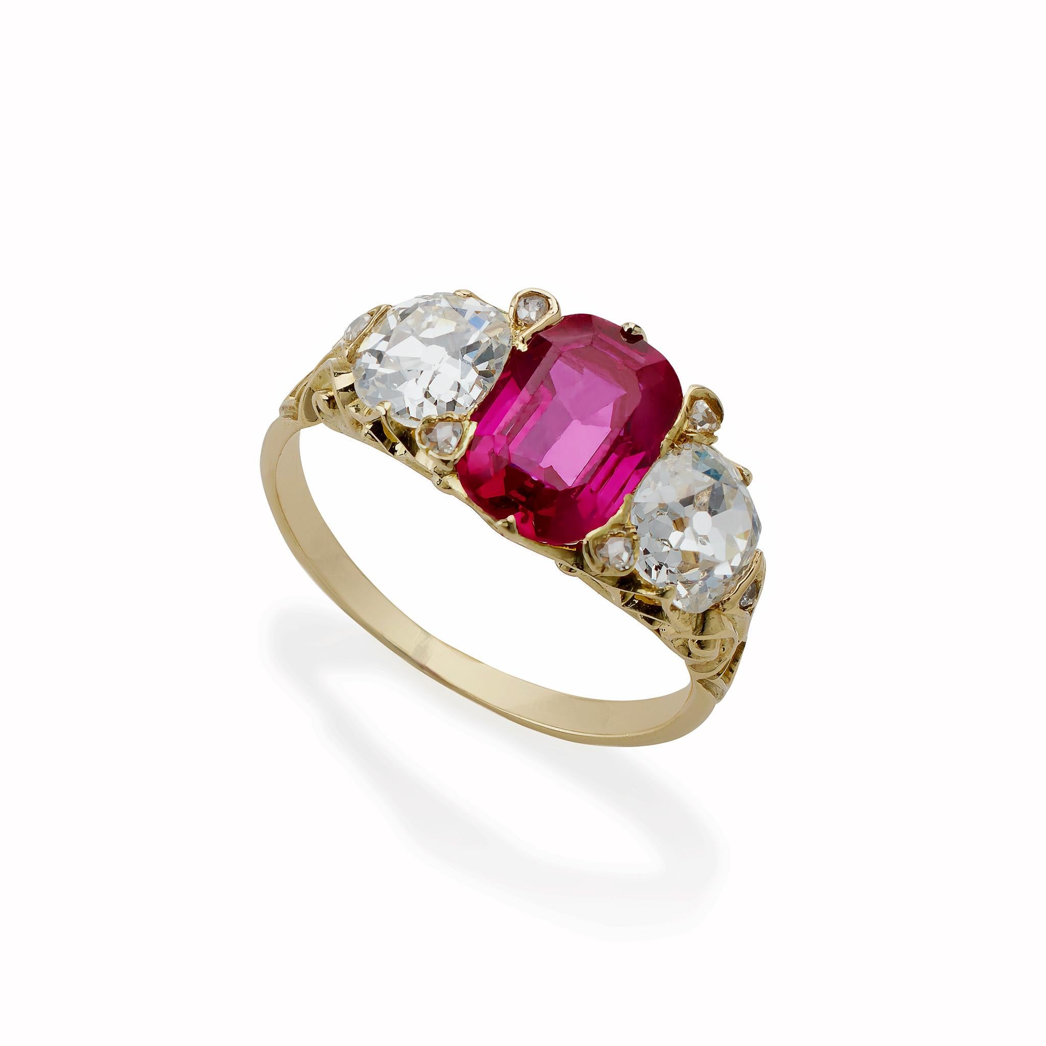 Mounted in the 1890s, this Burmese ruby is set in 18K gold with antique-cut diamonds. The rectangular step-cut ruby with rounded corners, measuring approximately 9.30 x 6.00 x 3.40 mm, weighing approximately 1.90 carats, is flanked by 2 old mine-cut
