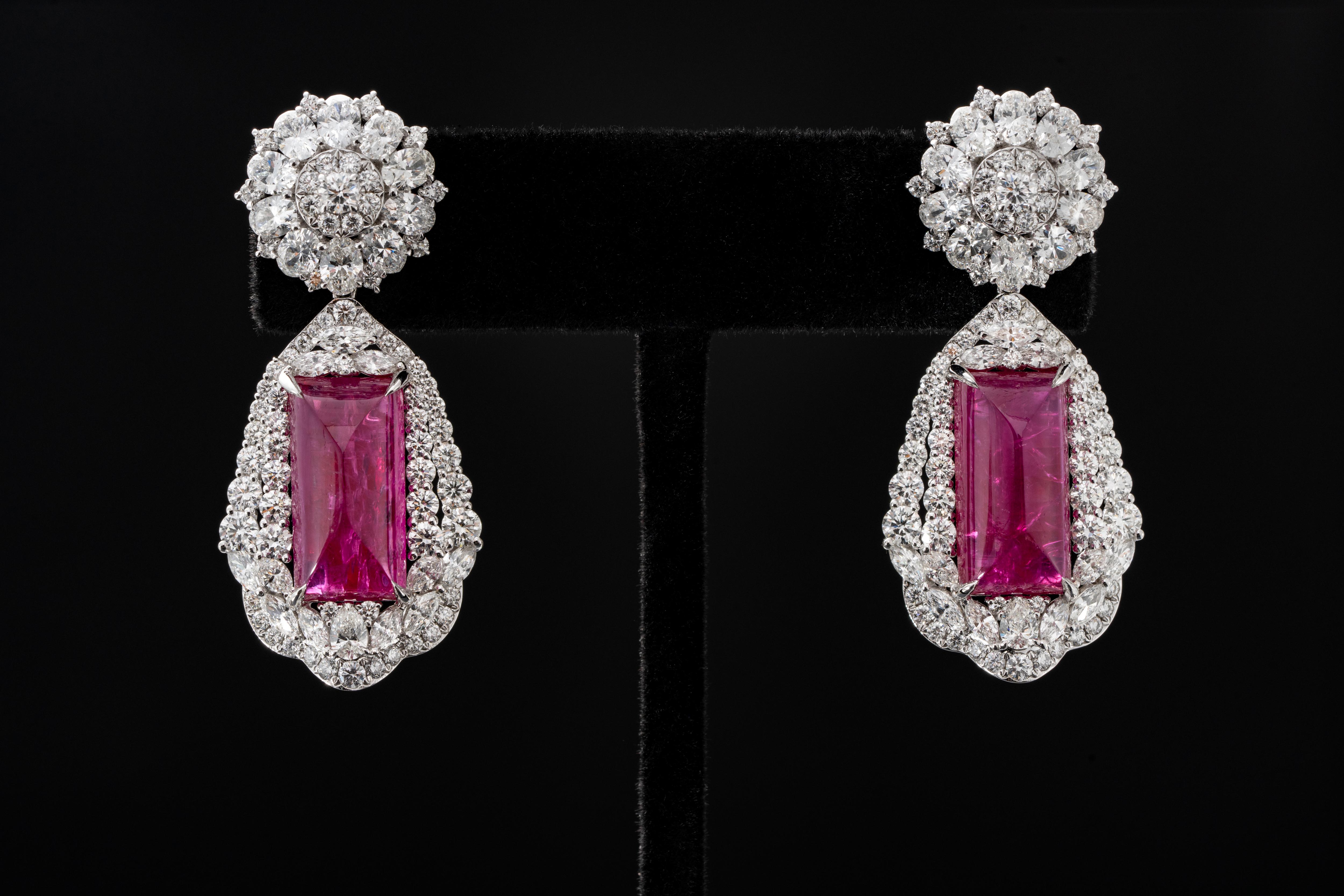 The pair of earrings ,each set with a rectangular-shaped Burmese Cab no heated ruby weighing 12.54 and 14.40 carats respectively.
The presence of the ruby larger than 10 carats is worth for celebration for gem collectors, and it is over 10 carats