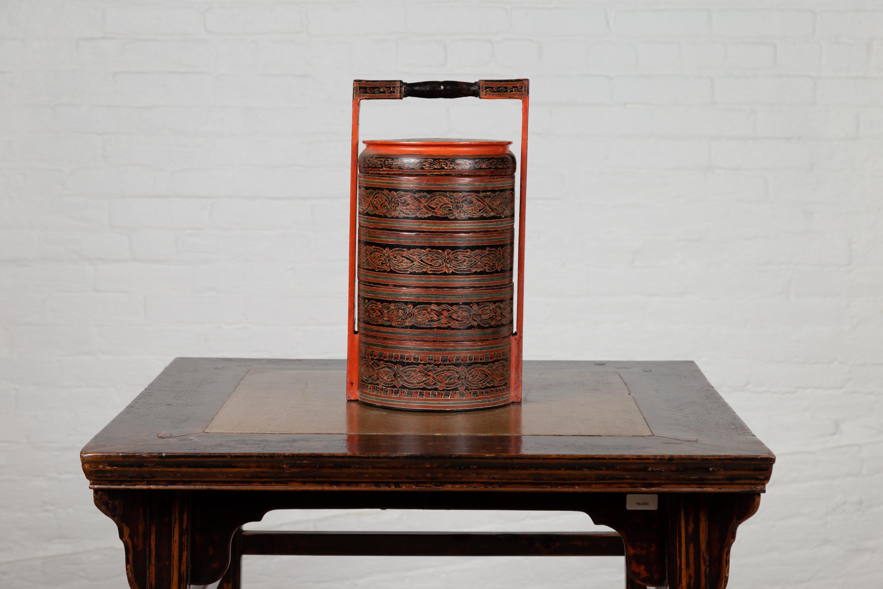 A vintage Burmese Pagan dynasty style stacking picnic cylinder basket from the mid-20th century, with multi-color underglaze decor. Born in Burma during the mid-century period, this charming stacking picnic basket features the stylistic traits of