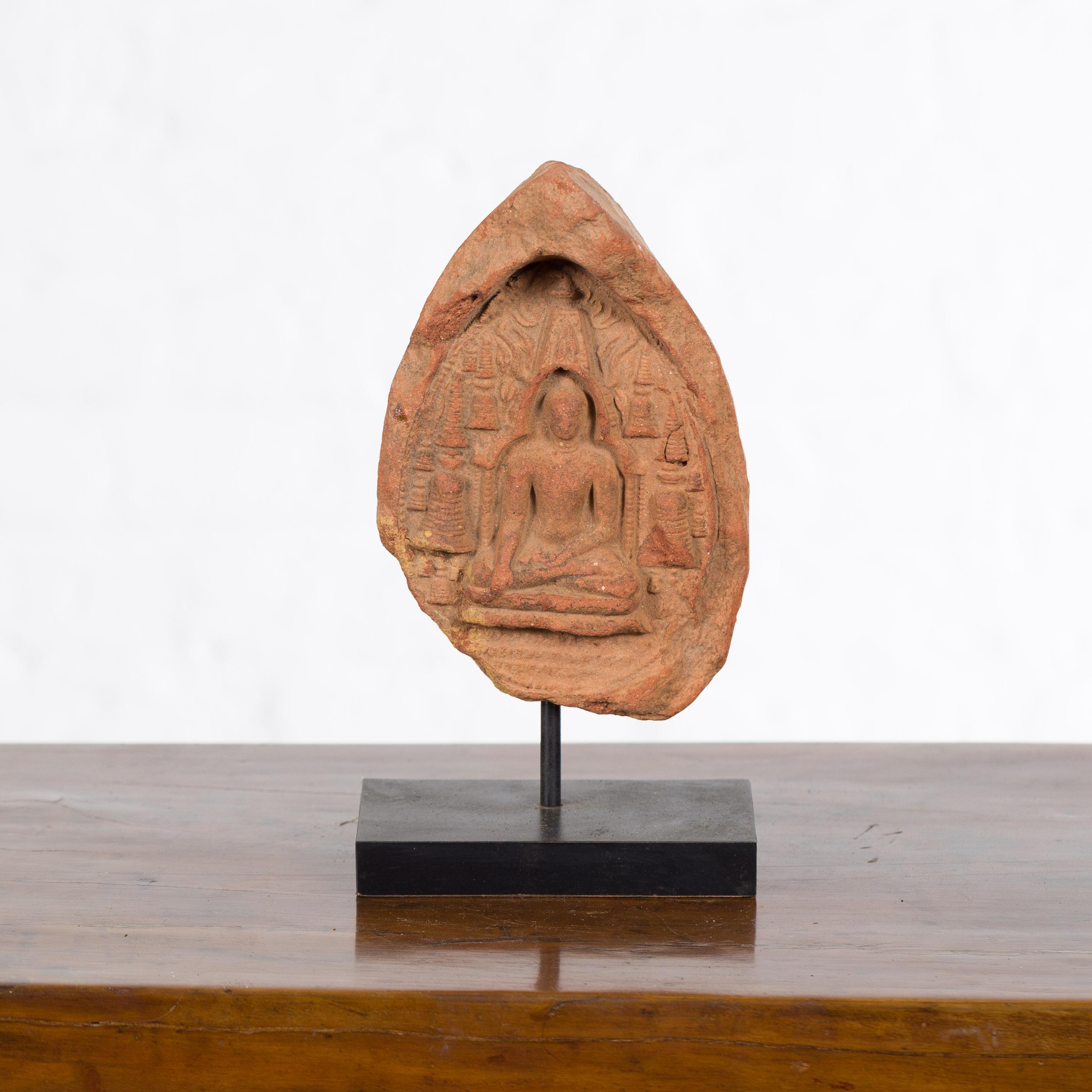 A Burmese Pagan Empire terracotta votive Buddha antique sculpture from the 12th or 13th century, mounted on a modern custom stand. Created in Burma during the Pagan Kingdom reign, this antique terracotta sculpture depicts the Buddha calling the