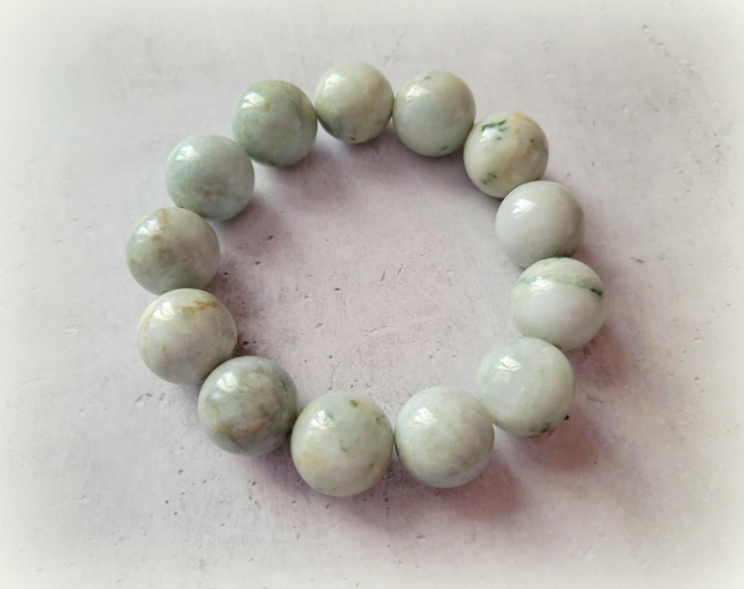 Fabulous Jade bracelet!
The bracelet is 9 inches long (22.8 cm) and weighs 115 grams (4 oz). The smooth round beads are 17.5 mm in size.

The jade beads are a soft seafoam green with darker shades of green. They look and feel sumptuous, and the