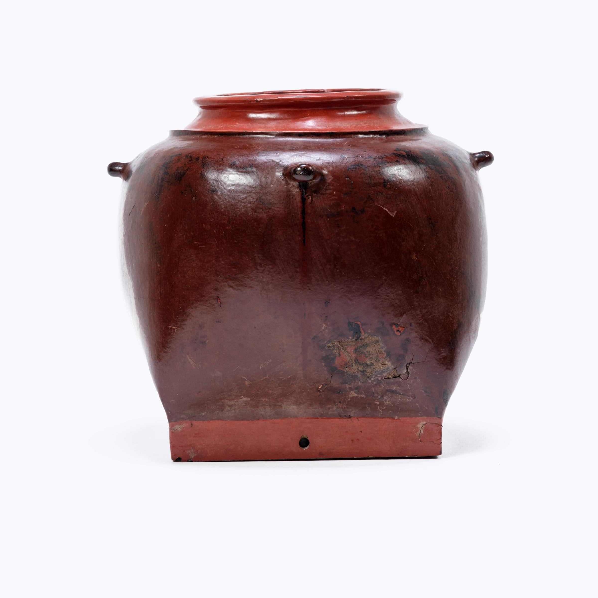 This round Burmese vessel was likely designed as hanging storage for everyday use. A thin core structure of wood and clay was then cloaked in red cinnabar lacquer for stability and decoration. The remarkably lightweight vessel is wonderful as a