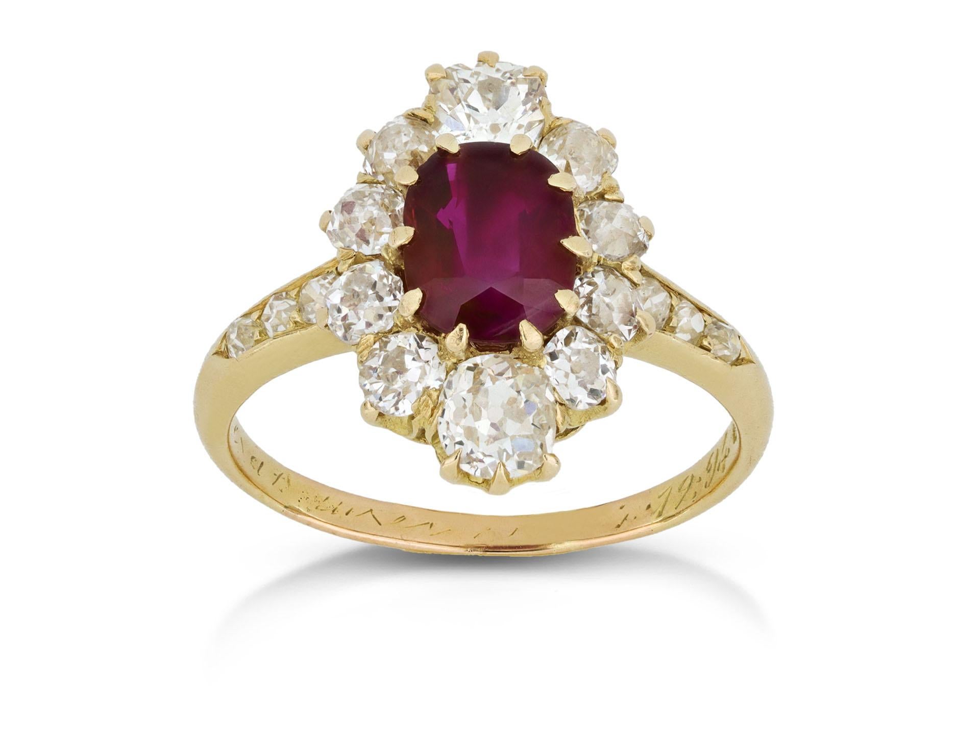 Burmese Ruby and diamond coronet cluster ring. Set to centre with a cushion shape old cut natural no heat Burmese ruby in an open back claw setting with an approximate weight of 1.30 carats, encircled by ten cushion shape old mine diamonds in open
