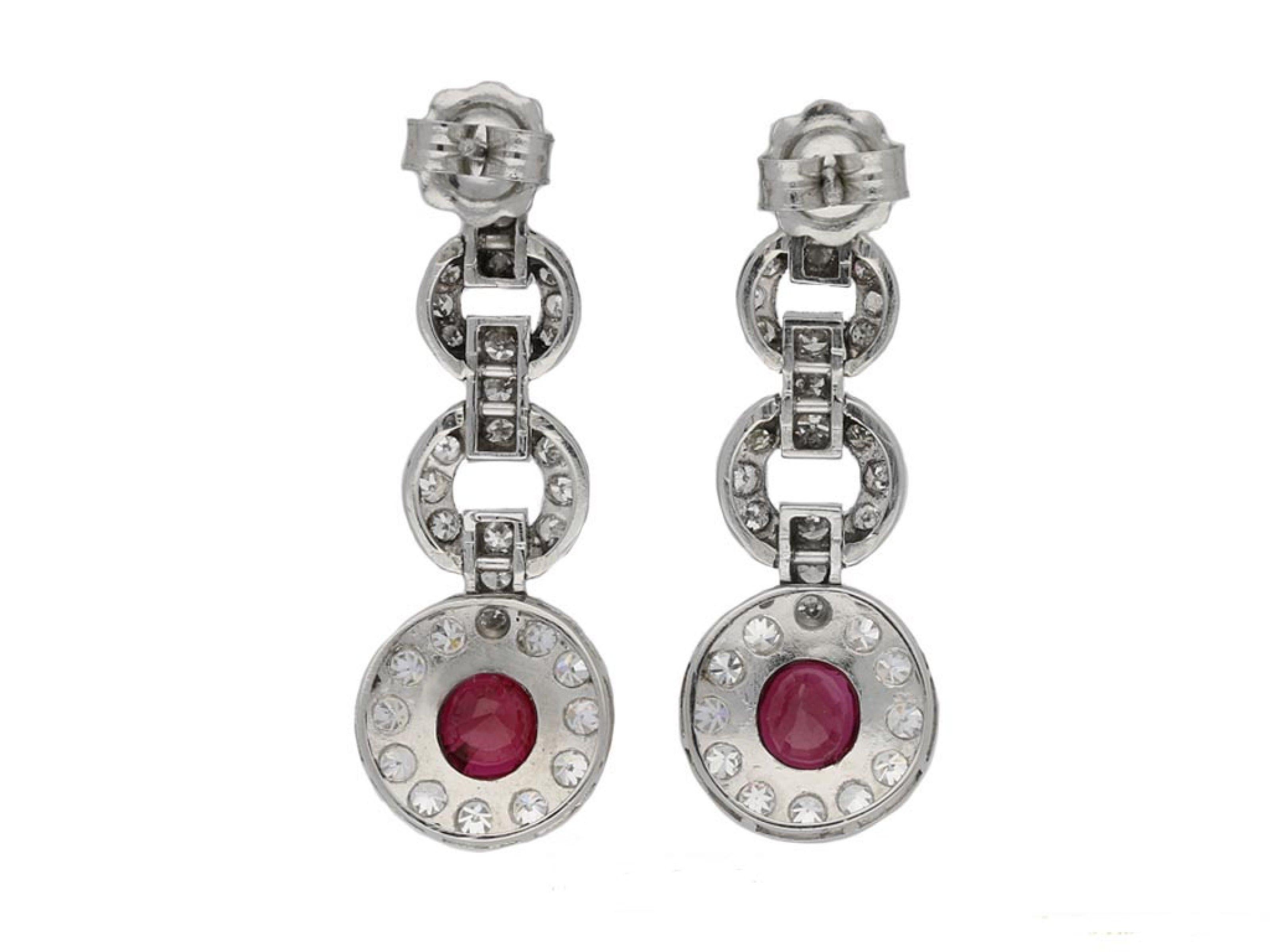 Burmese ruby and diamond earrings. A matching pair of earrings, each set with a cushion shape old cut natural unenhanced Burmese ruby in an open back rubover setting, one approximately 1.13 carats, the other approximately 1.04 carats, further
