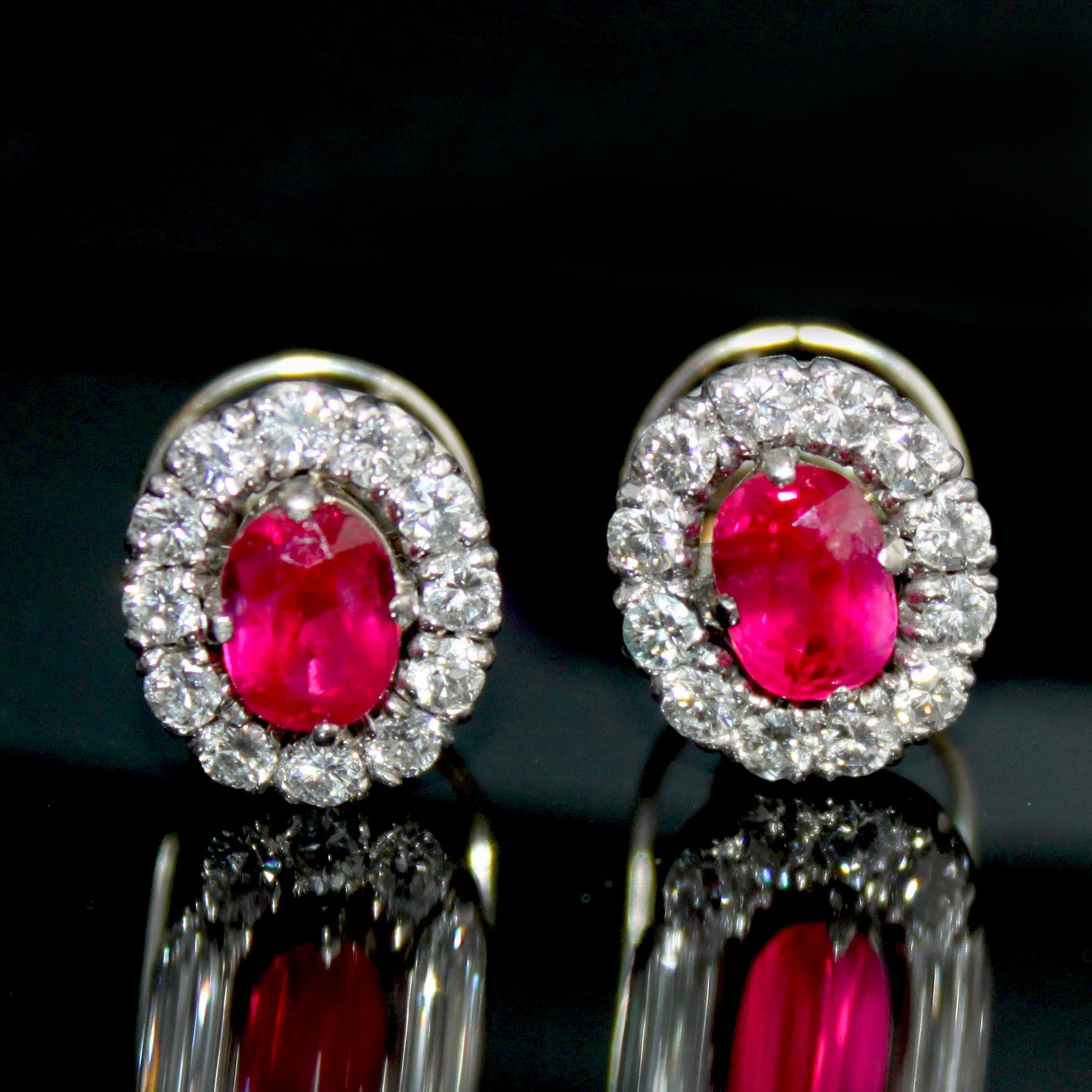 A pair of earstuds with rubies and diamonds. The rubies are of Burmese (Myanmar) origin and are natural (not heated) gemstones - accompanied by a gemological certificate by SSEF. Both rubies are cushion shaped and very well matched with a deep