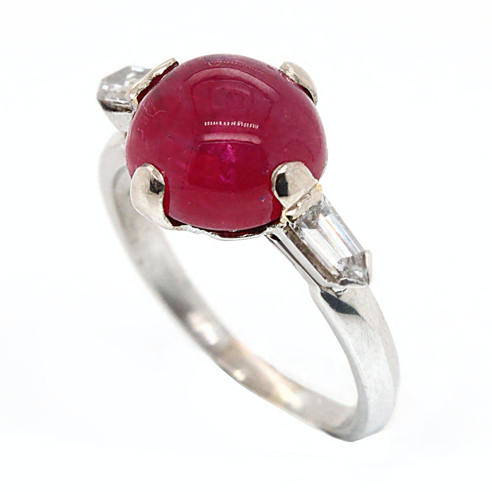 A large ruby cabochon and diamond Art Deco ring in white gold, ca. 1930s. The ruby weighs 6.26 carats and is accompanied by a gemological certificate stating that the stone is a natural ruby, not heat treated, and from Burmese (Myanmar) origin. It