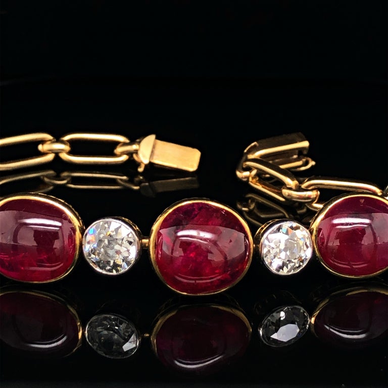 A rare Victorian ruby cabochon and diamond necklace/bracelet in yellow gold, ca. 1890s. It is bezel set alternately with five big ruby cabochons and six old European cut diamonds. 
The rubies have a captivating red colour and beautiful crystal, are