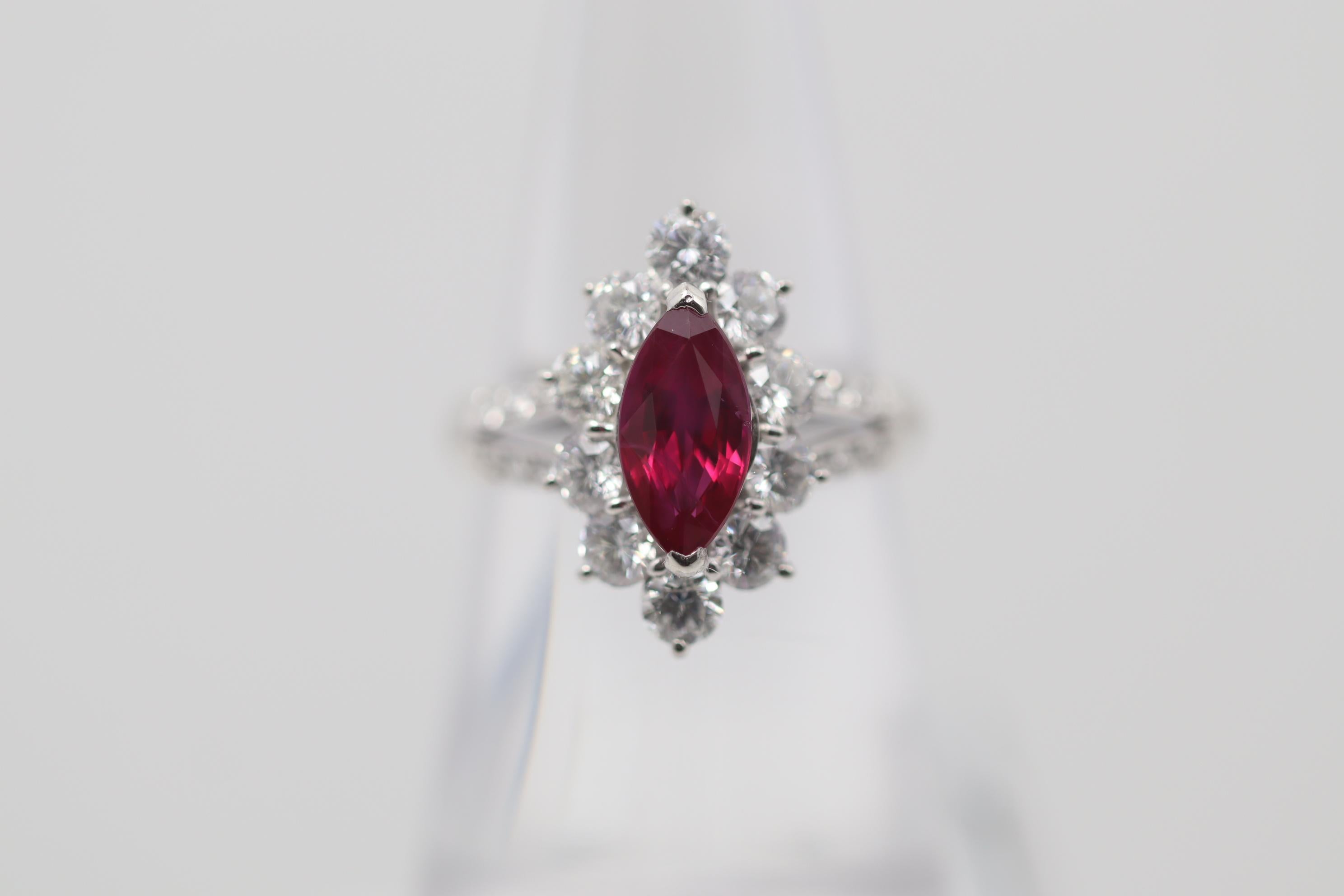 An elegant and chic ring featuring a 1.57 carat Burmese ruby which has been GIA certified. It has a lovely marquise-shape and a rich red color typical of Burmese stones. It is complemented by 1.31 carats of diamonds, larger diamonds surrounding the