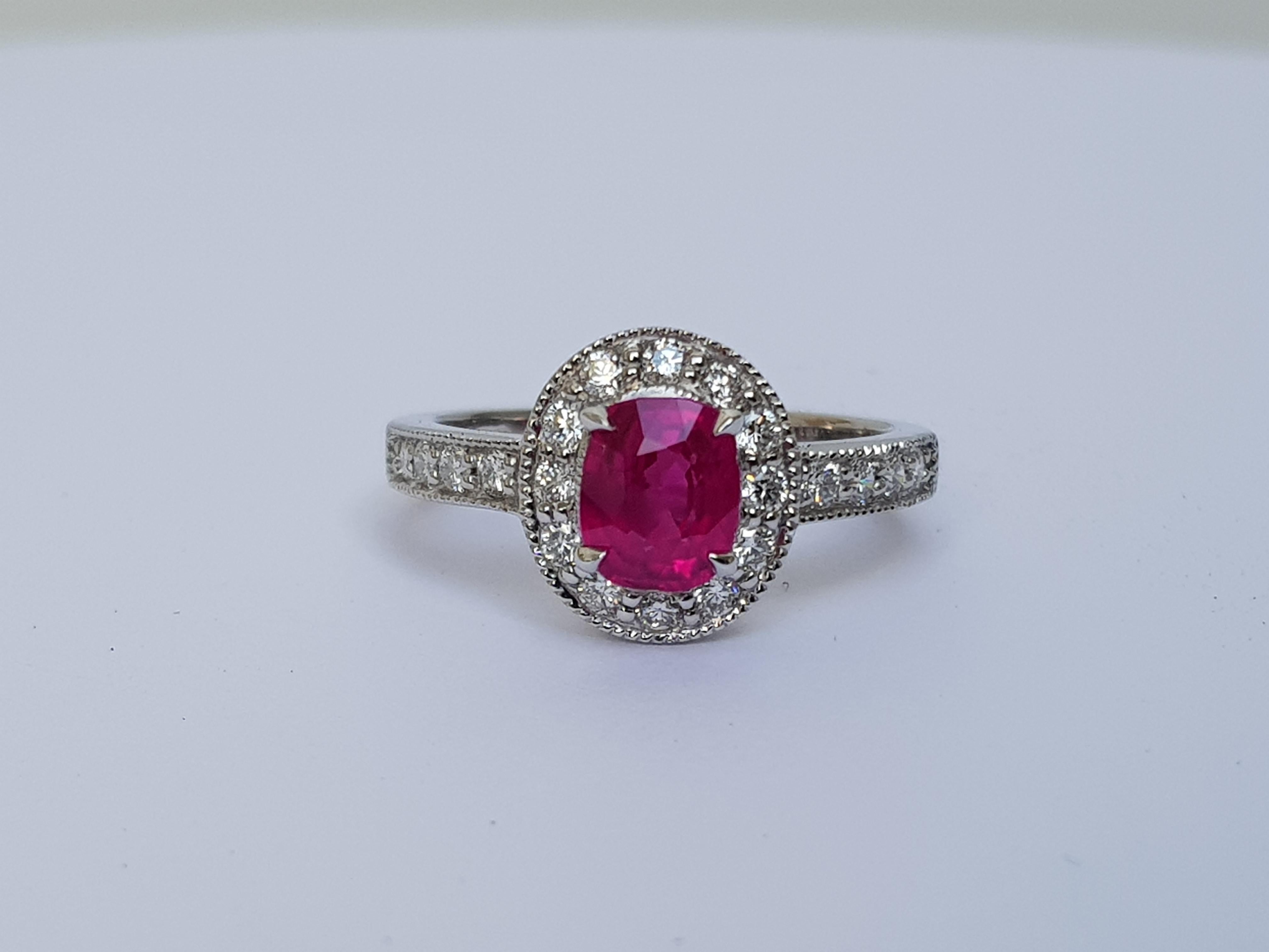 This beautiful art deco style ruby and diamond ring is comprised of an 18K White Gold band, 0.50 carats of round, white diamonds, and a unique central Ruby. 

The Ruby, which weighs 1.08 carats is of Burmese (Myanmar) origin, and has no indications