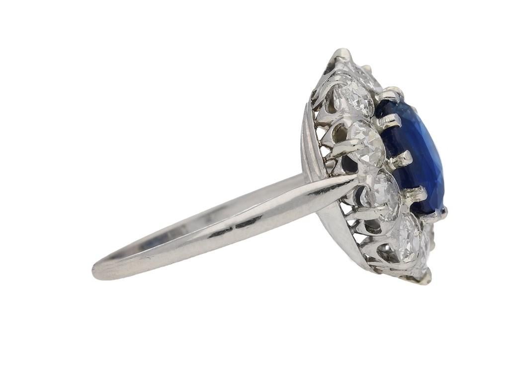 Burmese sapphire and diamond coronet cluster ring. Set with a round old cut natural unenhanced Burmese sapphire in an open back claw setting with an approximate weight of 3.51 carats, bordered by a single row of ten round old cut diamonds in open