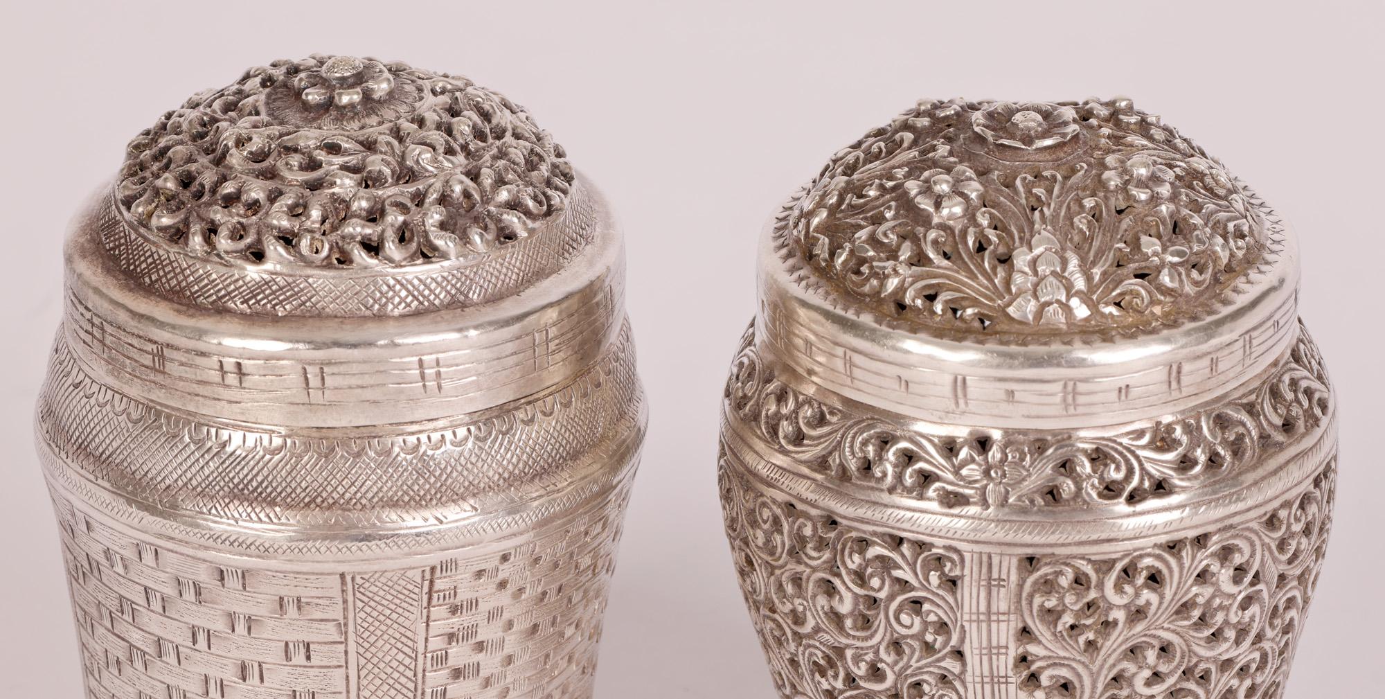 Two antique Burmese silver basket shaped boxes, possibly Betel containers, one with a pierced scroll leaf design and the other with a molded basket weave design dating from the 19th or early 20th Century.

Betel boxes were used to hold and carry