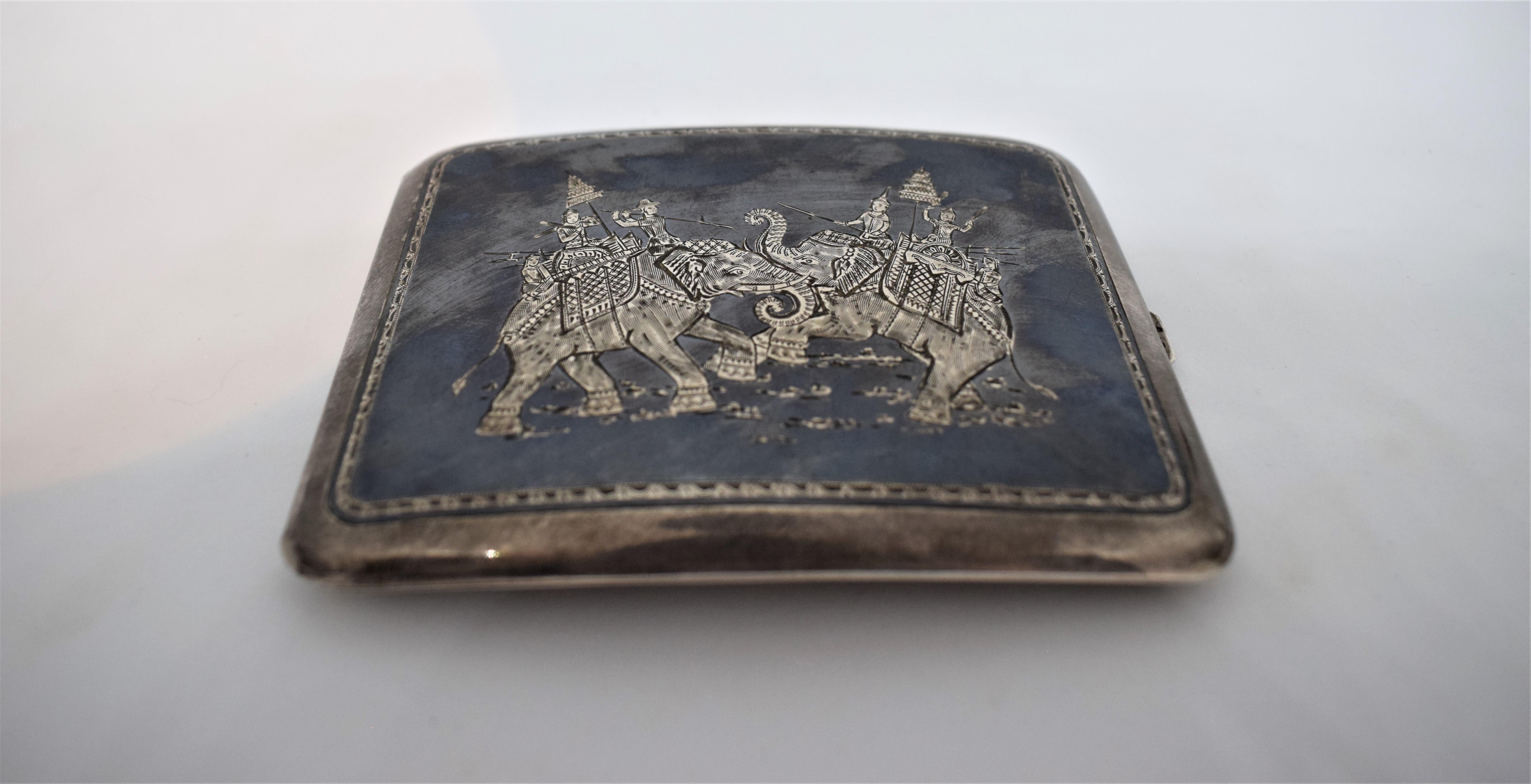 Burmese silver pocket cigarette case, late 19th century.

This well-crafted box is typical of Burmese work for the Anglo-colonial market in the pre-WWI period. The slightly-domed, hinged lid is decorated with an engraved image depicting the mighty