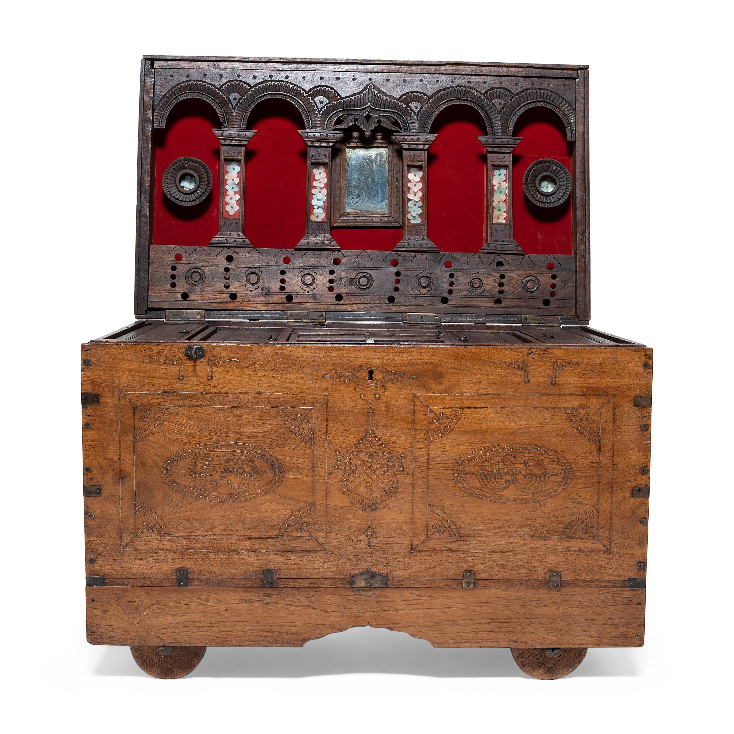 This unassuming wooden trunk is an early 20th century actor's chest from Mandalay, Burma. Used by a traveling opera performer or stage actor, the trunk opens to reveal several interior compartments for storing costumes, makeup, money, and personal