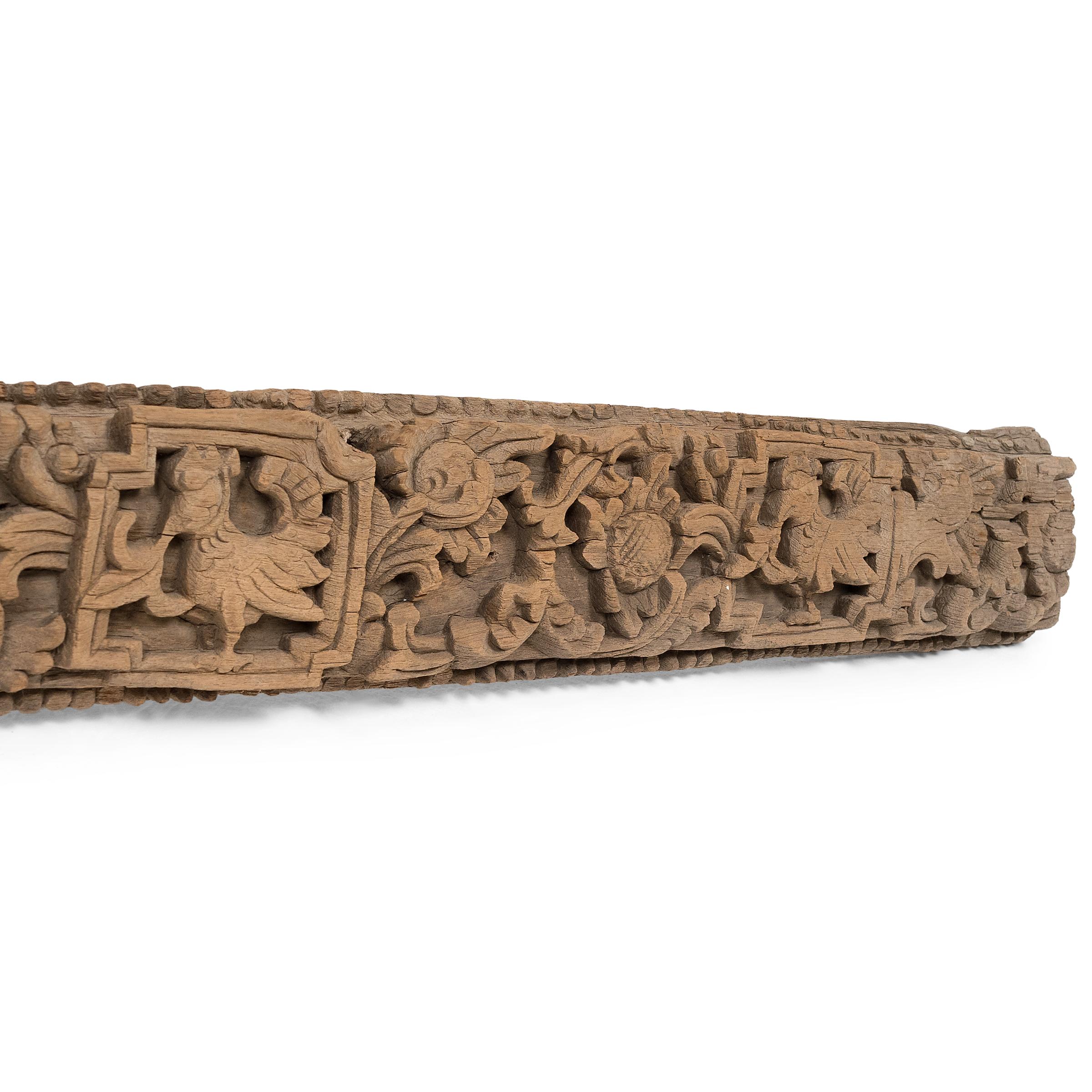 This teakwood lintel from 19th-century Burmese architecture is beautifully carved in relief with alternating patterns of birds, flowers and fruits. An architectural lintel is a horizontal beam placed over doors or windows in traditional Asian