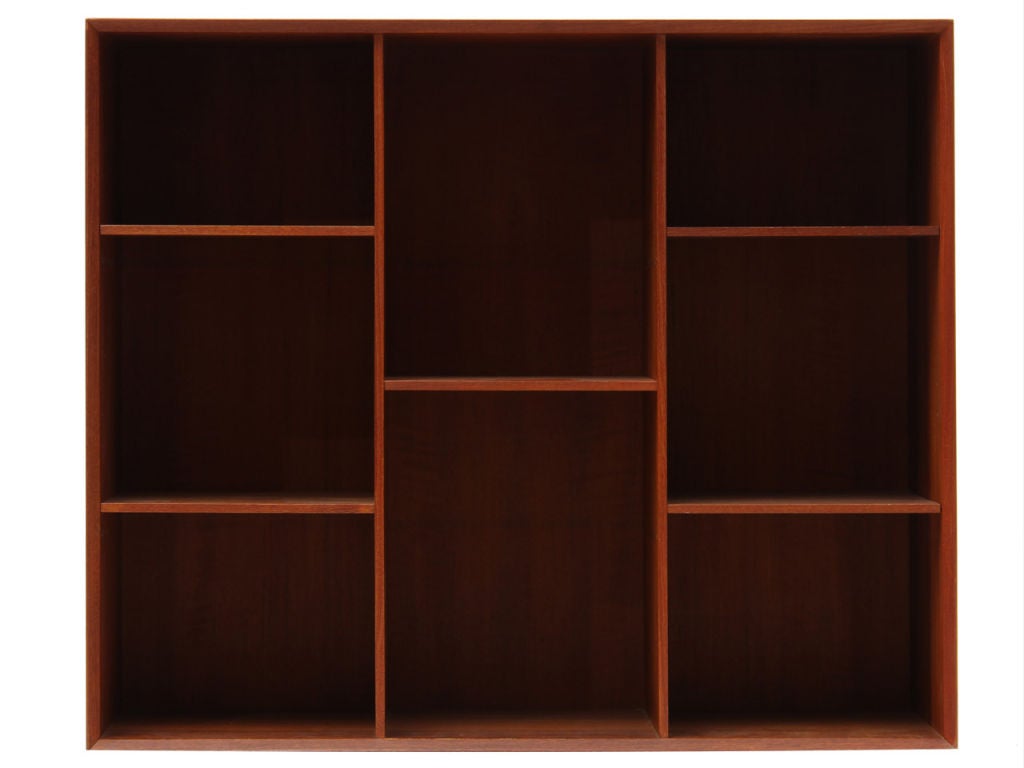 A Scandinavian Modern stackable bookcase by Peter Hvidt & Orla Mølgaard-Nielsen. Made from solid Burmese teak, the bookcase features adjustable shelving and finger jointed details. Produced in Denmark circa 1950s. 
Bookcase is removable from base,