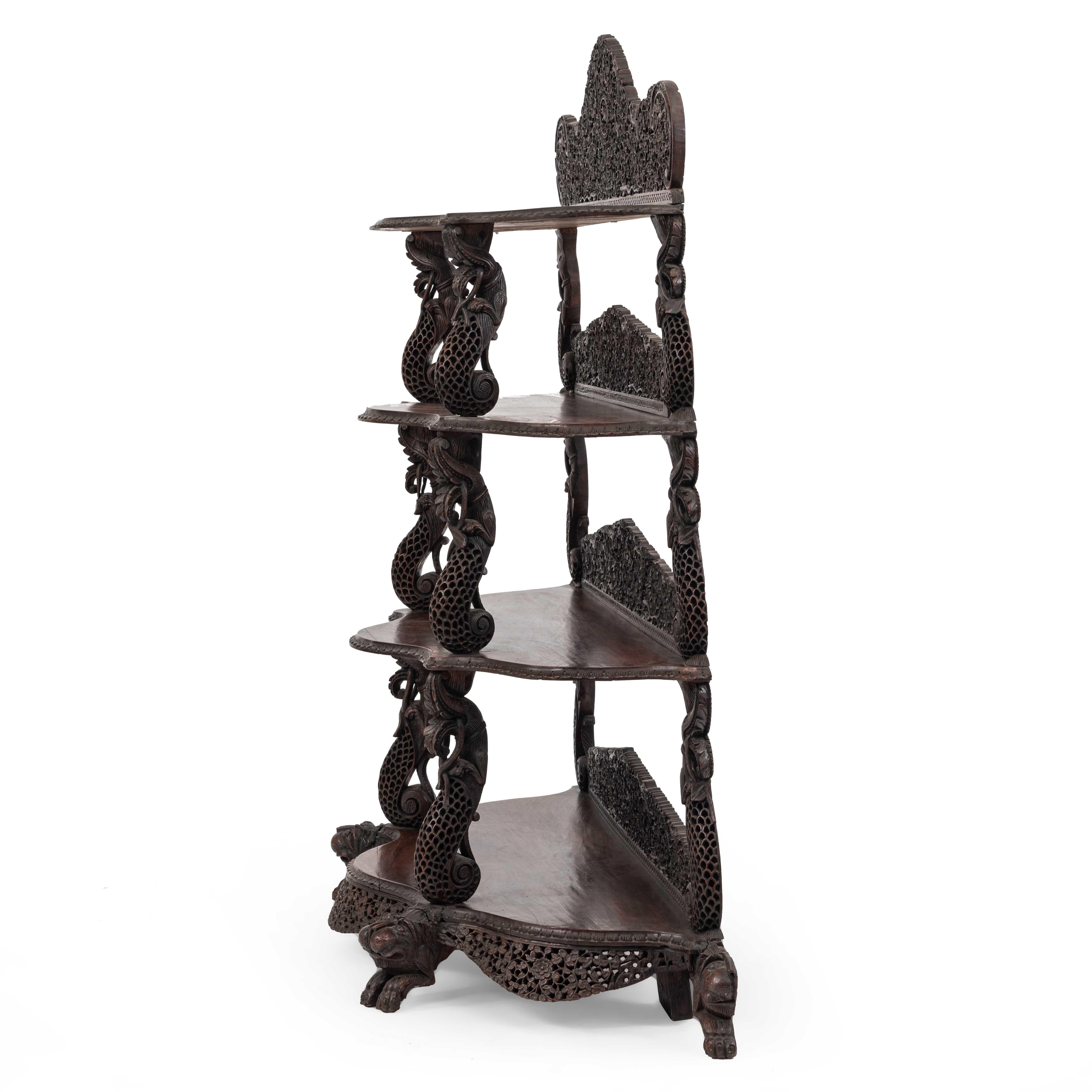 Asian Burmese-style (19th Century) teakwood serpentine shaped étagère with 4 shelves and filigree carved backrails.