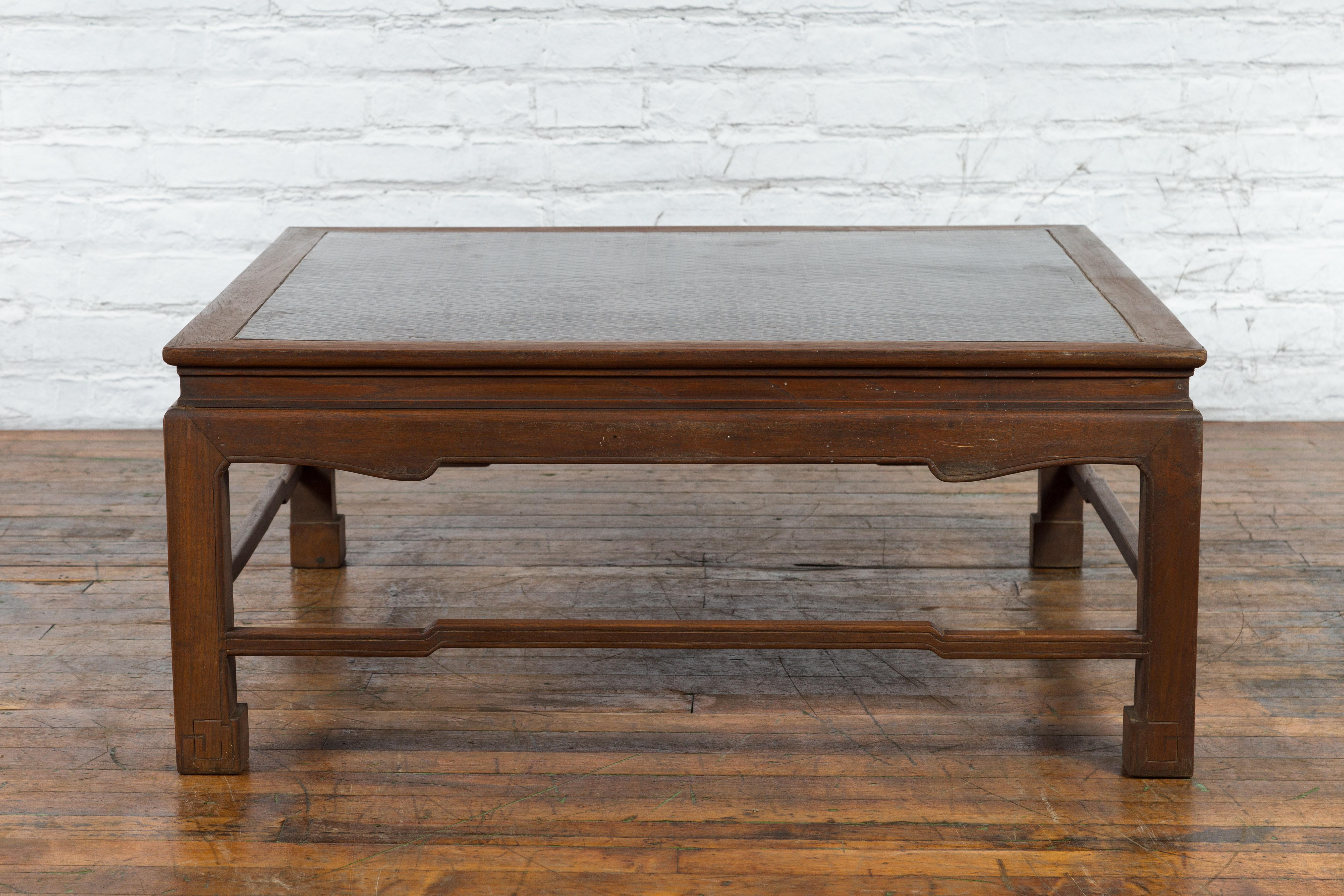 A vintage Burmese brown wood coffee table from the mid 20th century, with Negora lacquer inset top, horse hoof feet and hump back stretchers. We currently have two tables available should you need a pair. They are priced individually. Created in