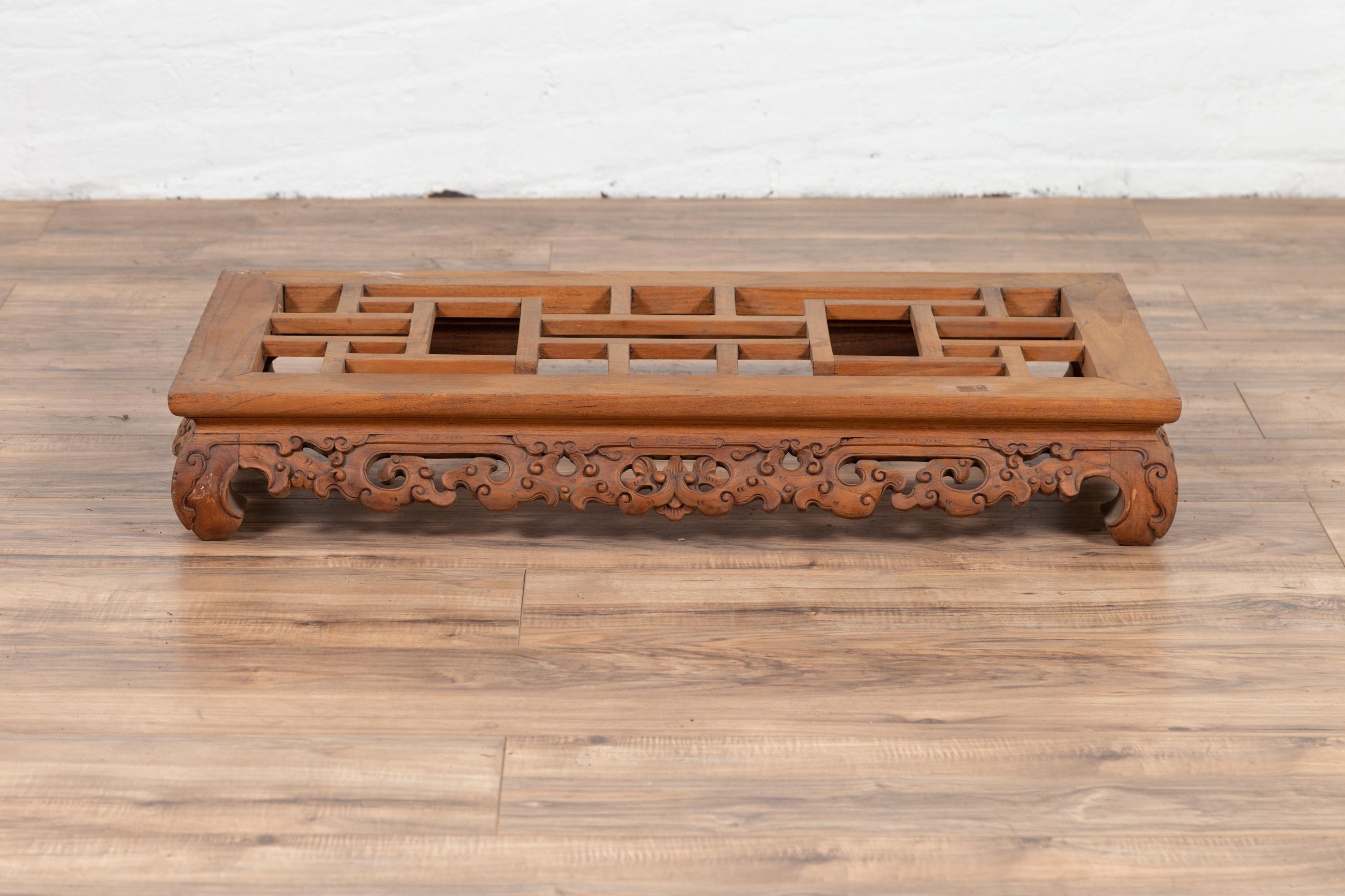 A small vintage Burmese low altar table from the mid-20th century, with carved scrolled apron and bulging legs. Born in Burma during the mid-century period, this exquisite small altar table features a rectangular waisted top with geometric design,