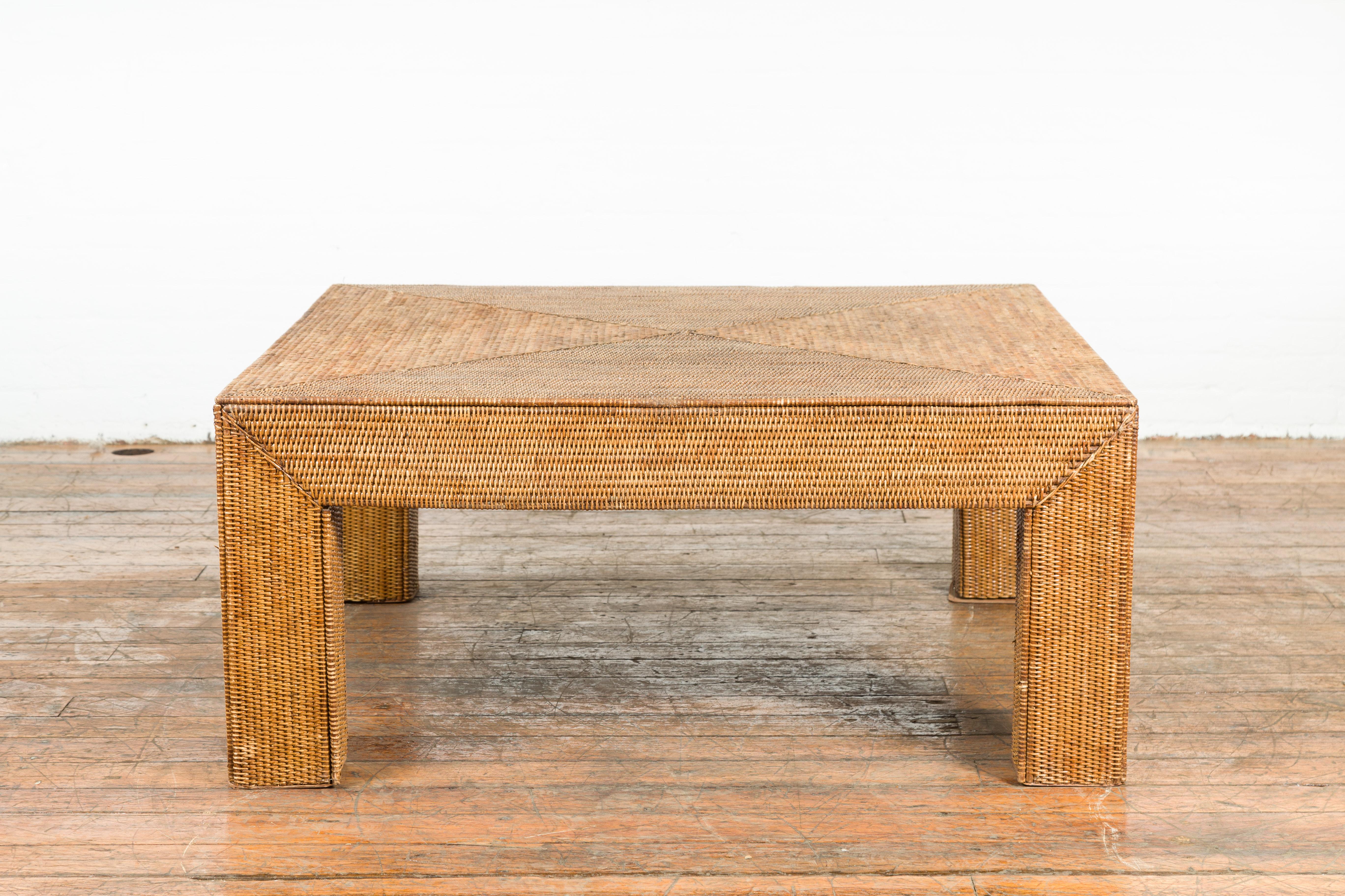 A Burmese vintage rattan parsons leg coffee table from the mid 20th century, hand-stitched over wood. We currently have several available, priced and sold $3,250 each. Created in Burma during the midcentury period, this Parsons leg coffee table