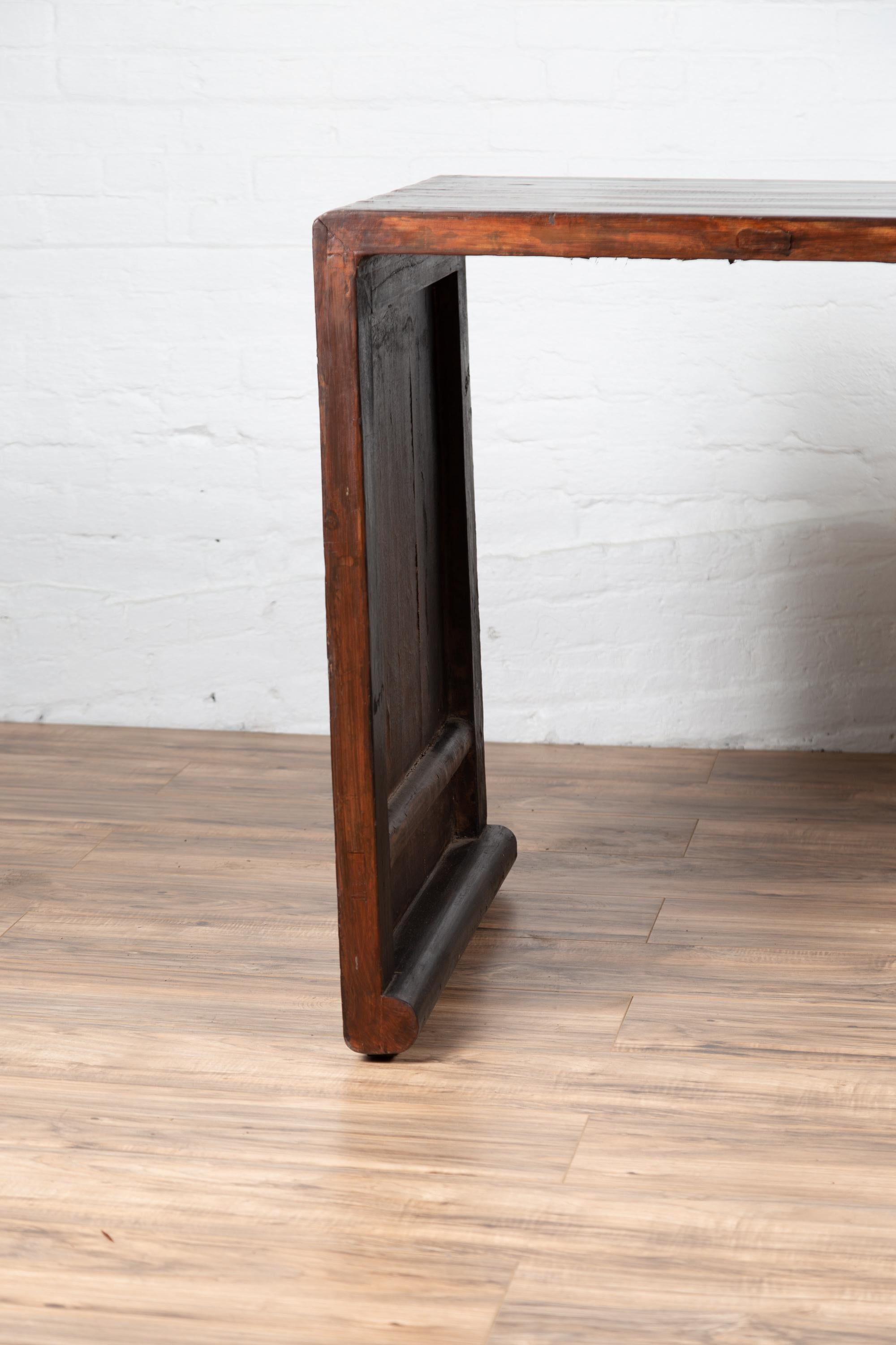 20th Century Burmese Vintage Waterfall Console Table with Scrolling Feet and Dark Patina For Sale
