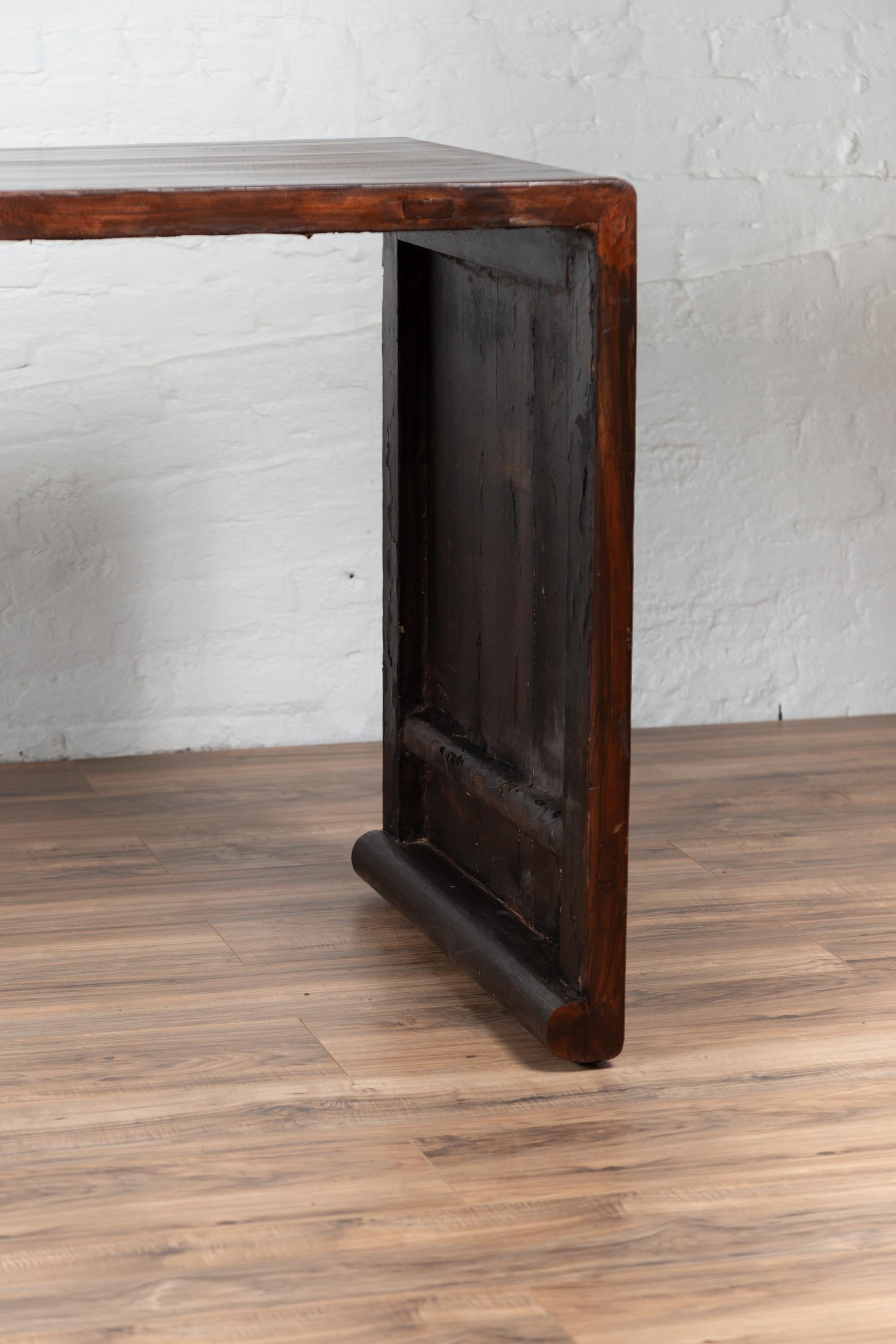 Wood Burmese Vintage Waterfall Console Table with Scrolling Feet and Dark Patina For Sale