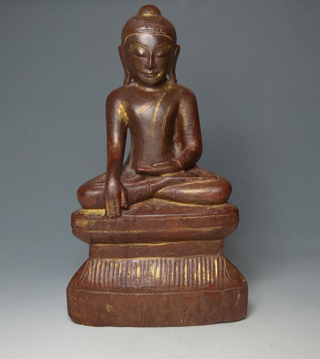 A superb large Burmese Shan wood Buddha, Circa 18th / 19th century
Beautiful and elegant example in carved hard wood with lacquer and gold gilt, the Buddha seated in the meditation posture with hands held in the Bhumisparsha mudra raised on a