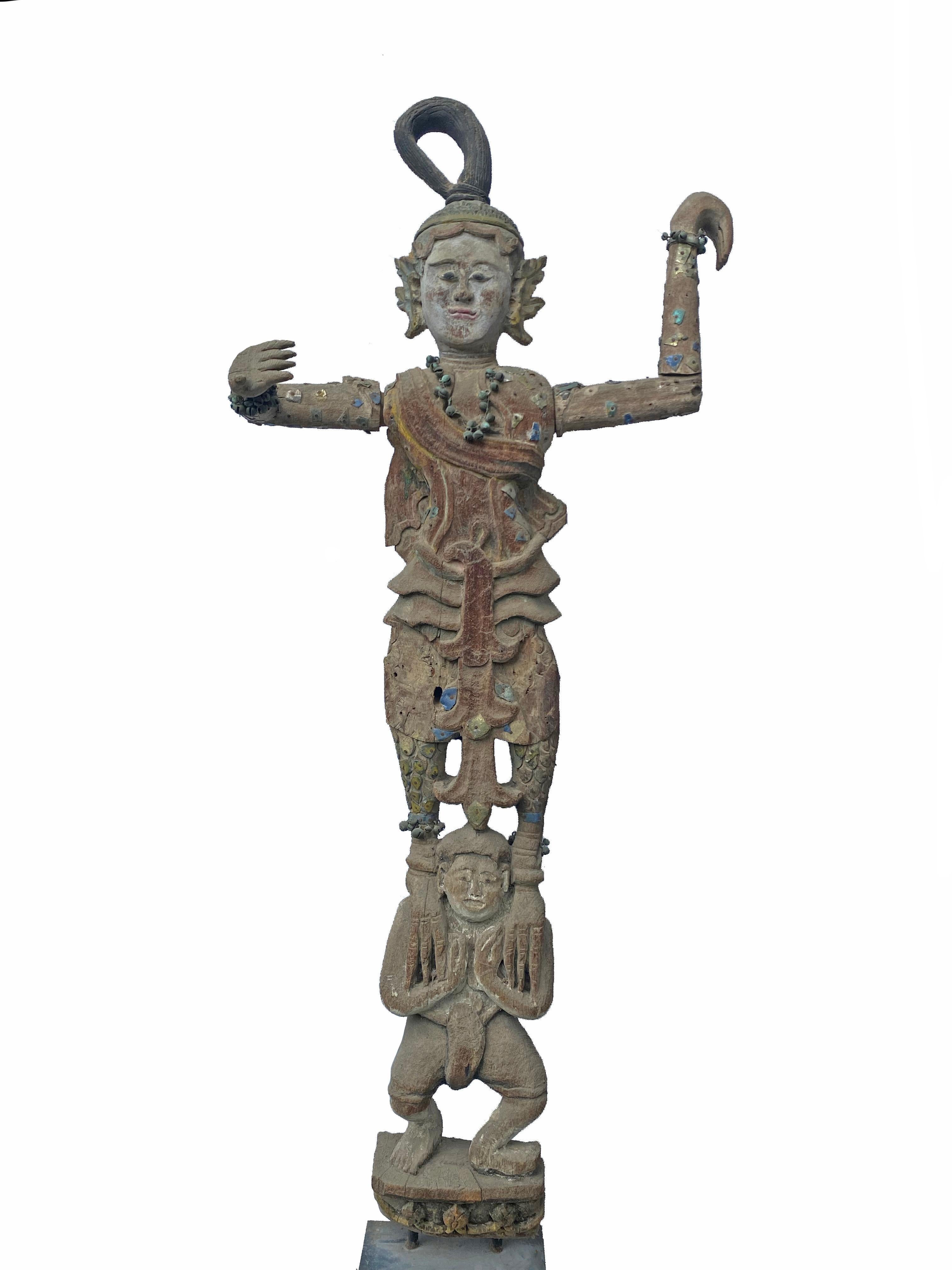 These statues are adorned wood-carved Burmese Mandalay 'Nat' Spirits from the early 20th century. Nats were worshipped by the Burmese people, depicted as supernatural guardians they offer protection and help to counter evil. Carved of teak they are