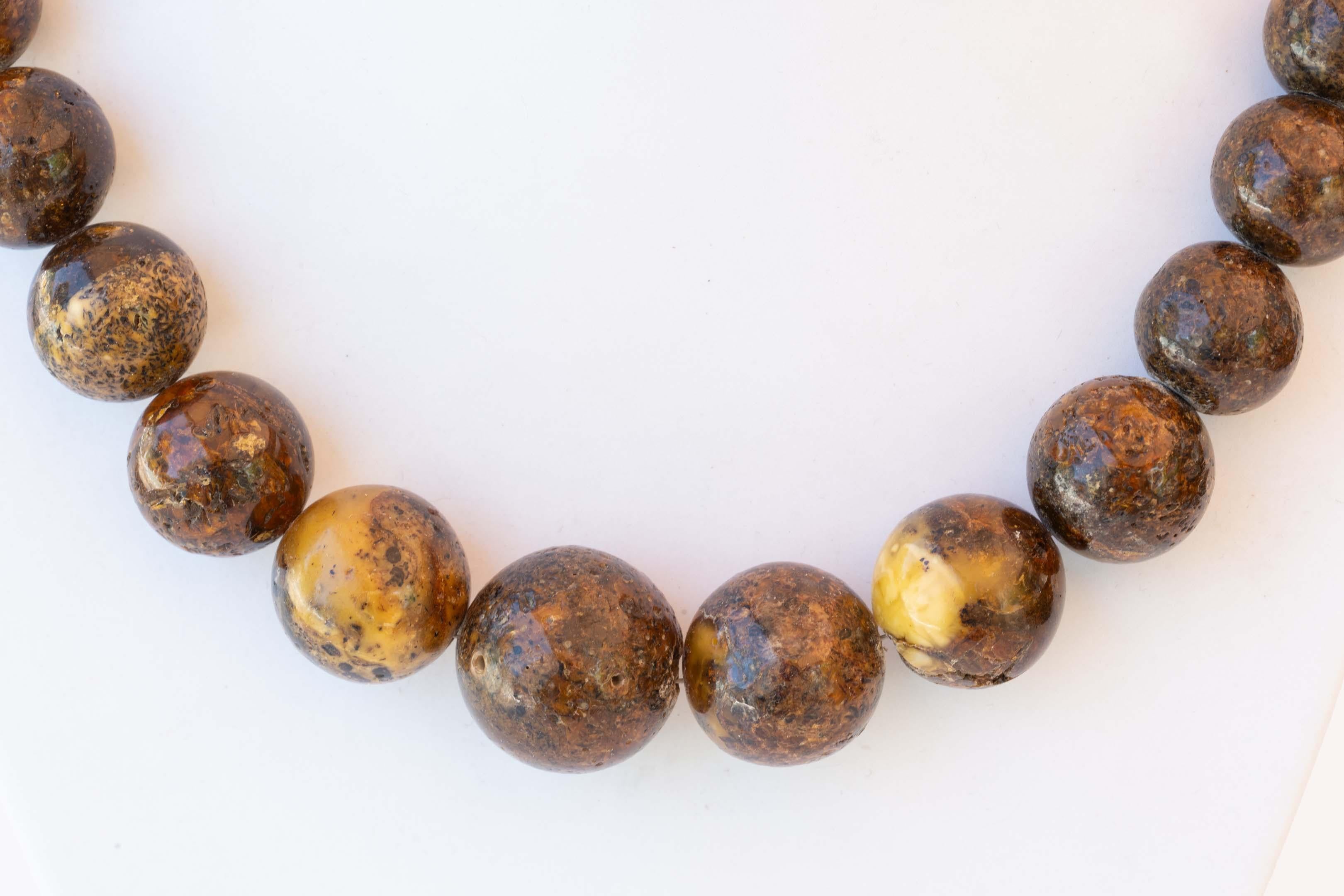 Natural Burmite root amber necklace measuring 20 inches long, weighs 82 grams. The beads are sized 13mm to 23 mm in diameter. Provenance from Burma region, tested in salt water.