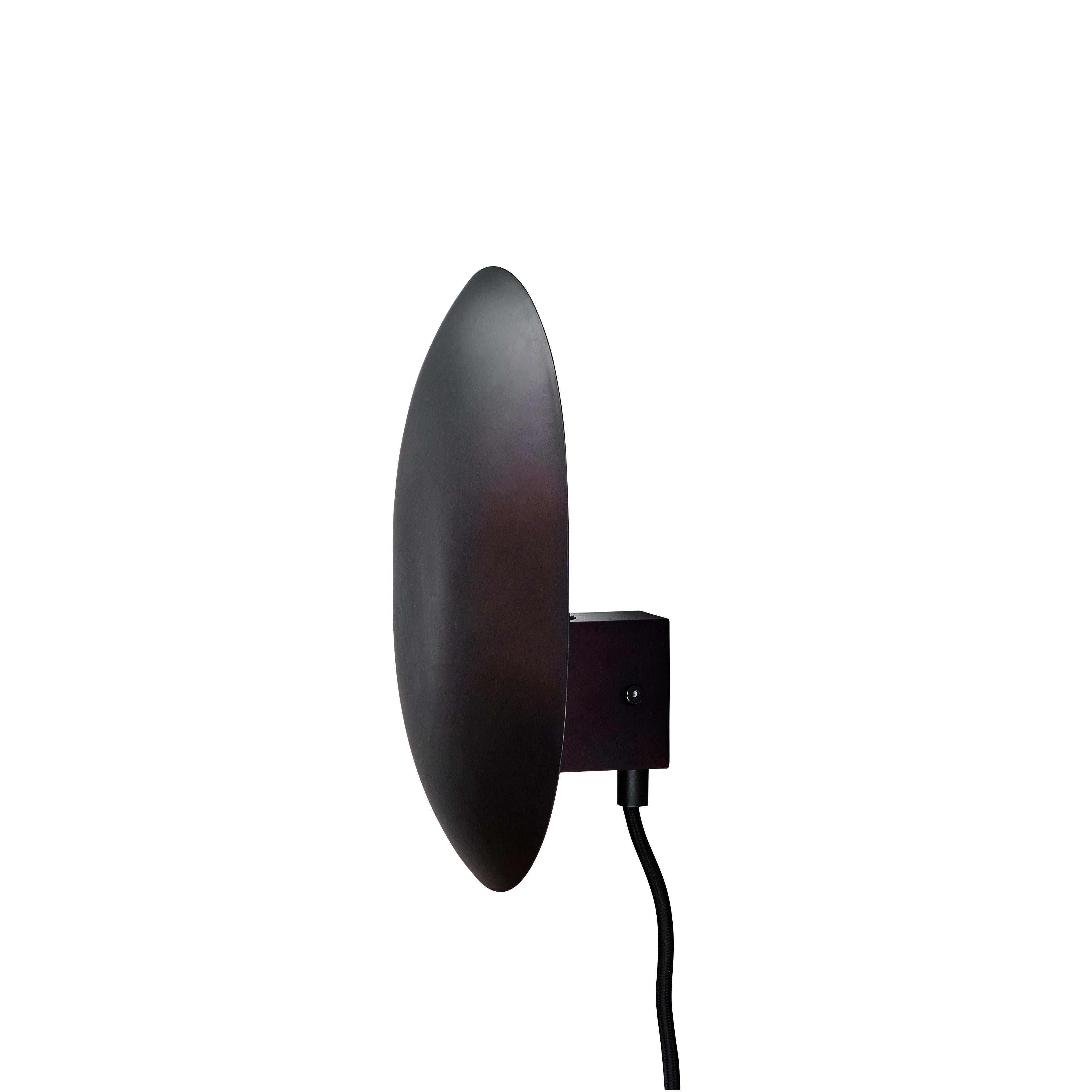 Burned black clam wall lamp by 101 Copenhagen
Designed by Kristian Sofus Hansen & Tommy Hyldahl
Dimensions: L 14 x W 22 x H 26 cm
Cable length: 170 cm

Materials: metal: plated metal / burned black
Cable: fabric covered cable /