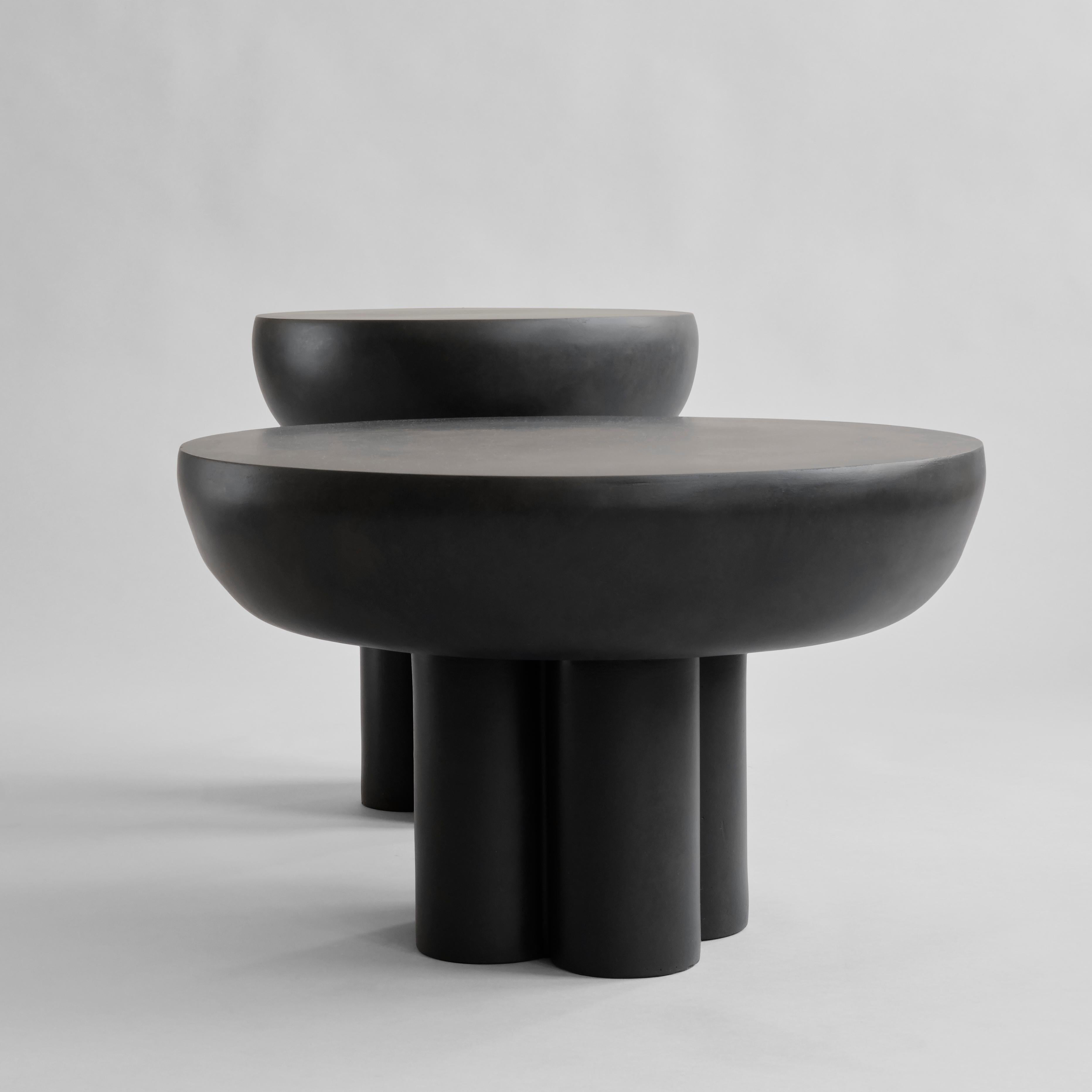 Burned Black Crown Table Low by 101 Copenhagen
Designed by Kristian Sofus Hansen & Tommy Hyldahl
Dimensions: L65 / W65 /H41 CM
Materials: Aluminum

The collection of tables entitled Crown is cast in one piece formed as a circular tabletop carried by