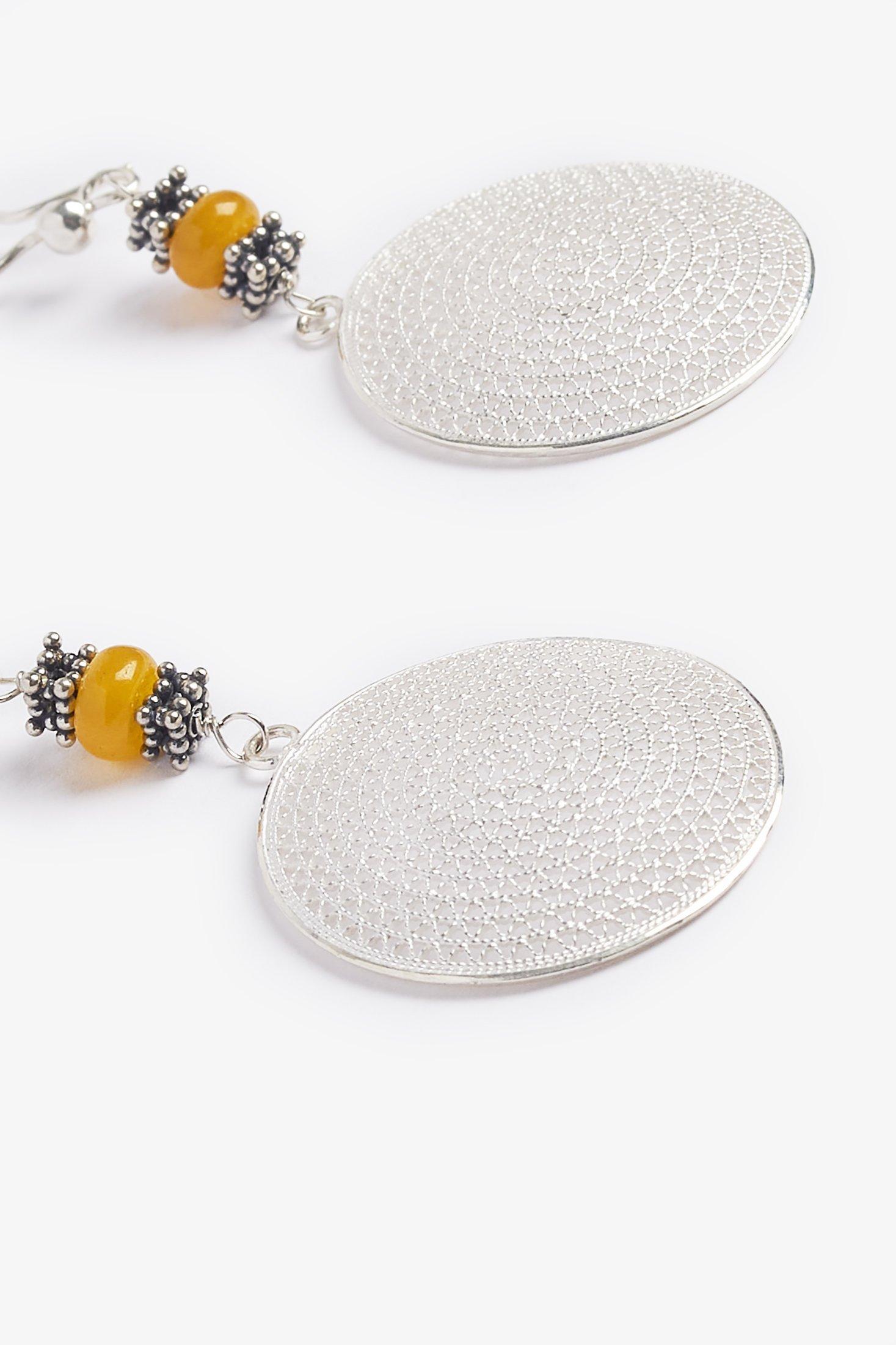 The unique medallions are from Indonesia with a detailed Sterling Silver design.  The earrings are accented with with yellow agate and Balinese beads. 

Properties
Agate has the power to harmonize the yin and yang.  It is a soothing and calming