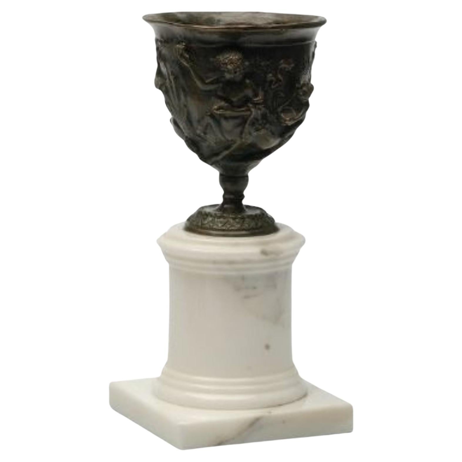 Hercules Burnish brass cup with Carrara marble base