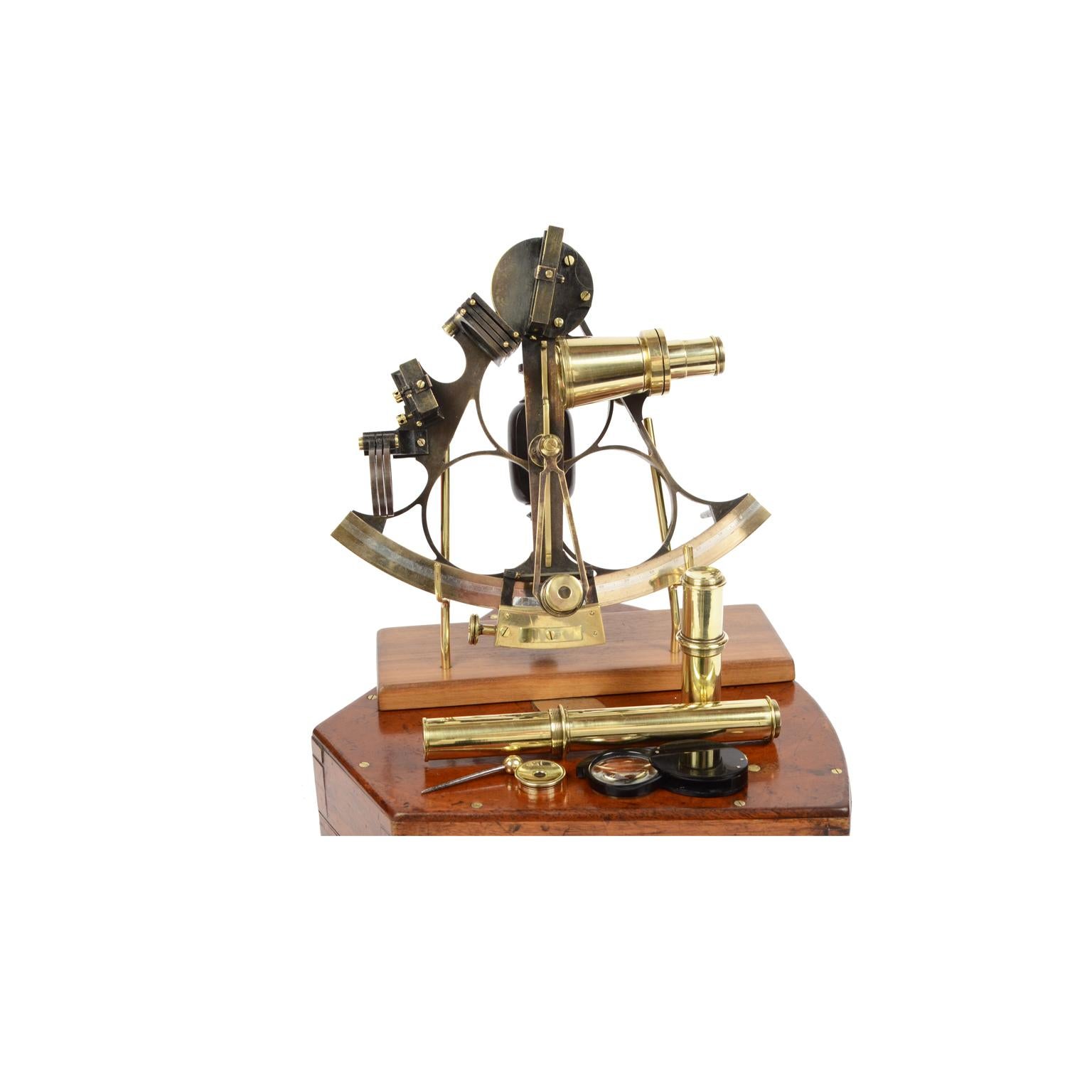 Burnished brass sextant made in the second half of the 19th century and placed in its beautiful original mahogany wood box shaped like the instrument, complete with a key lock with hinges and brass hooks. Flap and vernier made of silver, ebony