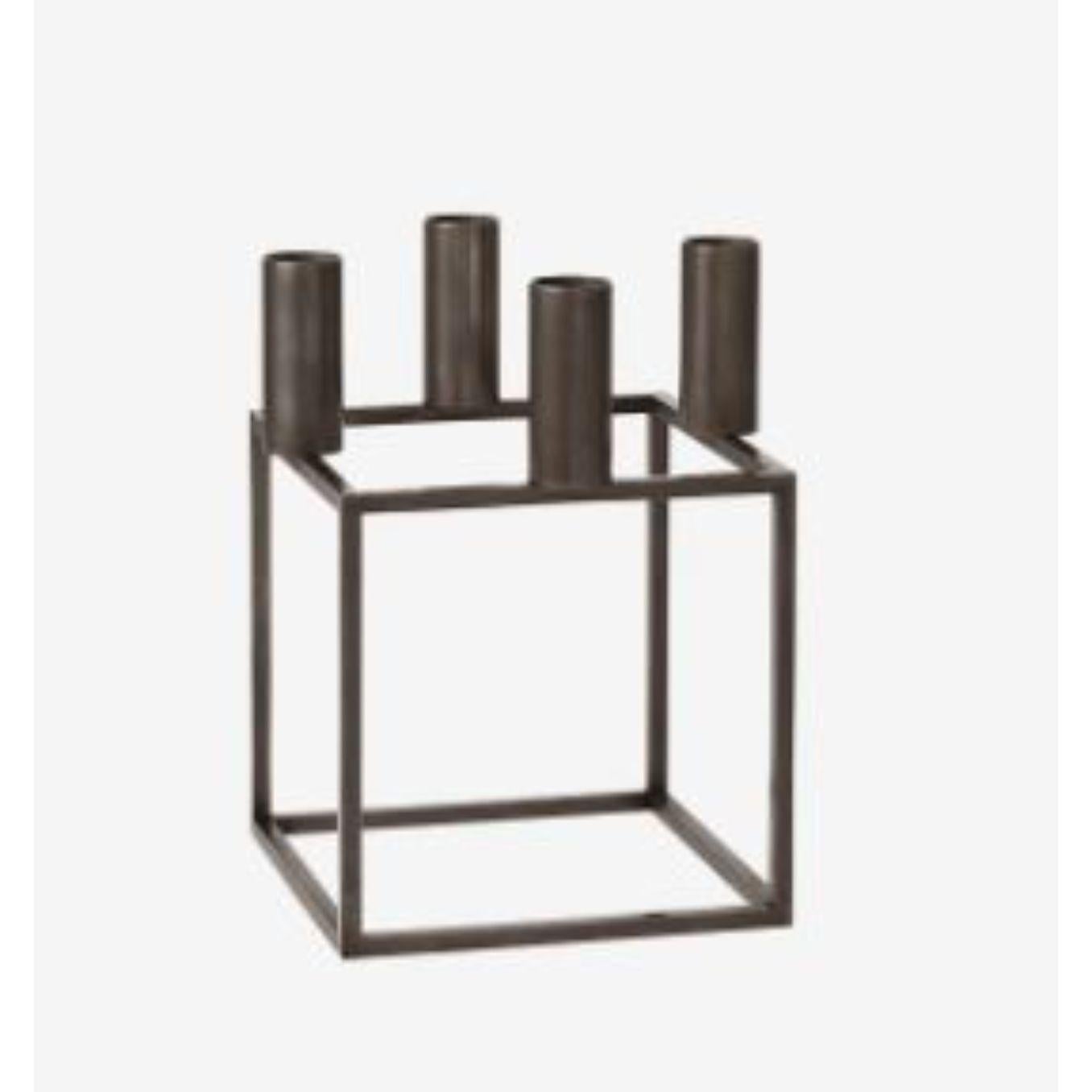 Burnished Copper Kubus 4 candle holder by Lassen
Dimensions: D 14 x W 14 x H 20 cm 
Materials: Metal 
Also available in different dimensions. 
Weight: 1.50 Kg

A new small wonder has seen the light of day. Kubus Micro is a stylish, smaller