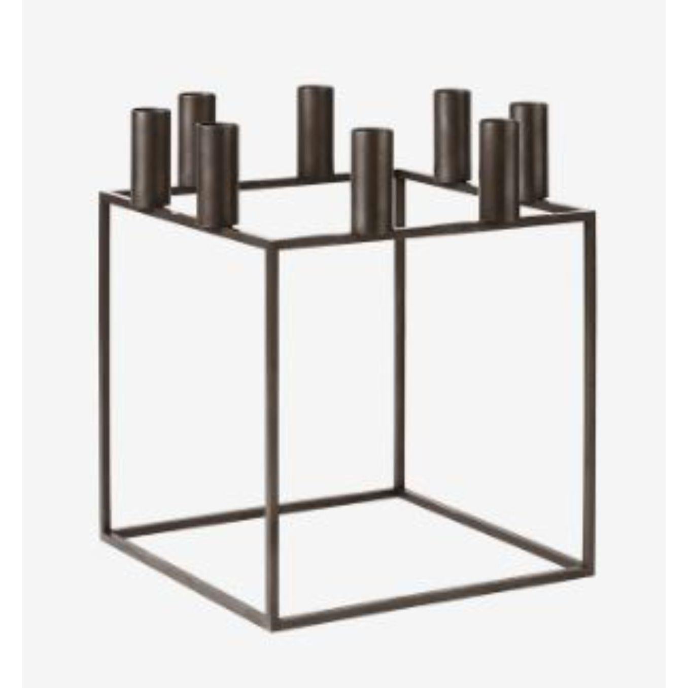 Burnished Copper Kubus 8 candle holder by Lassen
Dimensions: D 23 x W 23 x H 29 cm 
Materials: Metal 
Also available in different dimensions. 
Weight: 1.50 Kg

With a sharp sense of contemporary Functionalist style, Mogens Lassen designed the