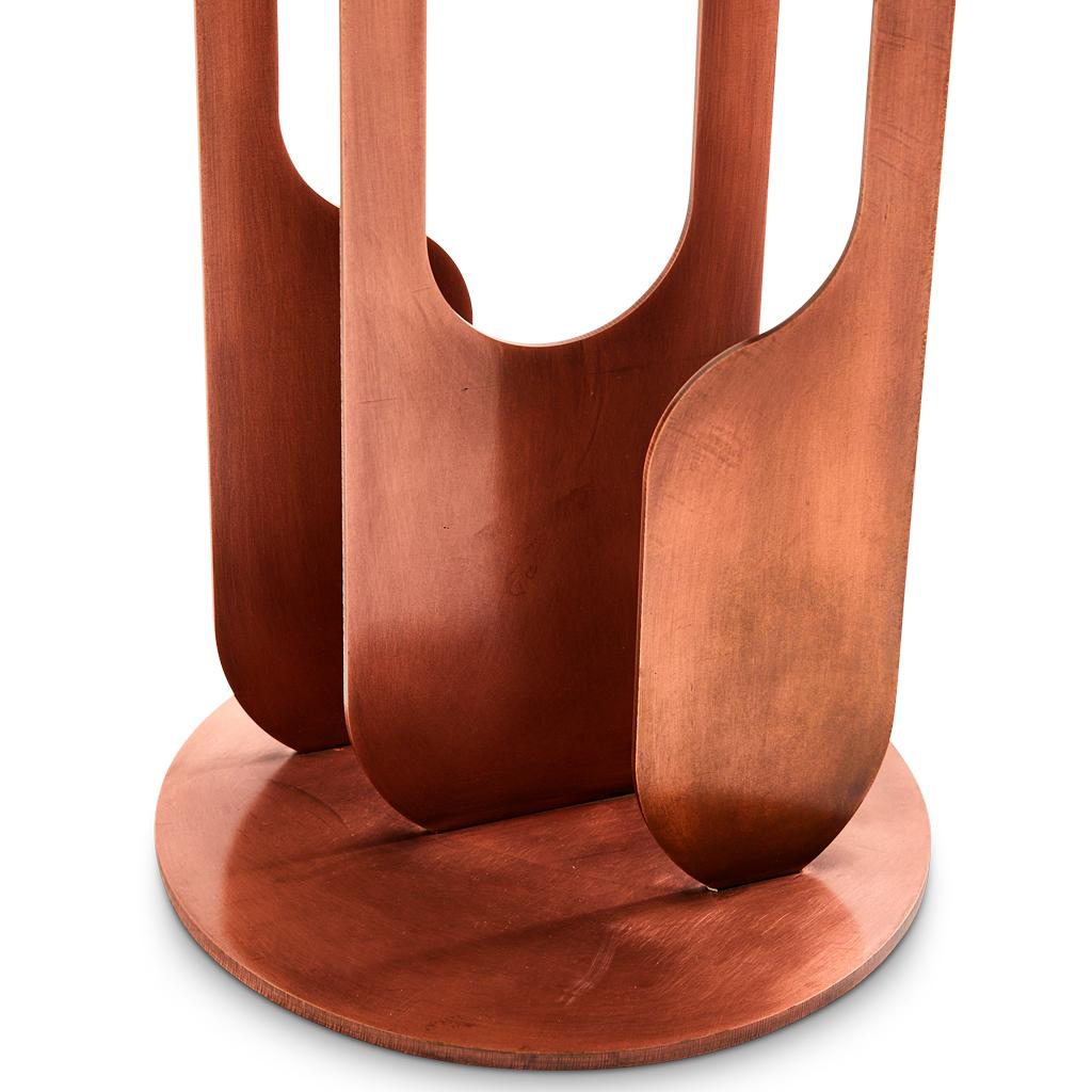 The Drop Side Table has a resewn oak timber top, showcasing Egg Designs' commitment to blending organic materials with architectural forms. The warm wooden surface rests atop a burnished copper-plated steel base, creating a harmonious balance