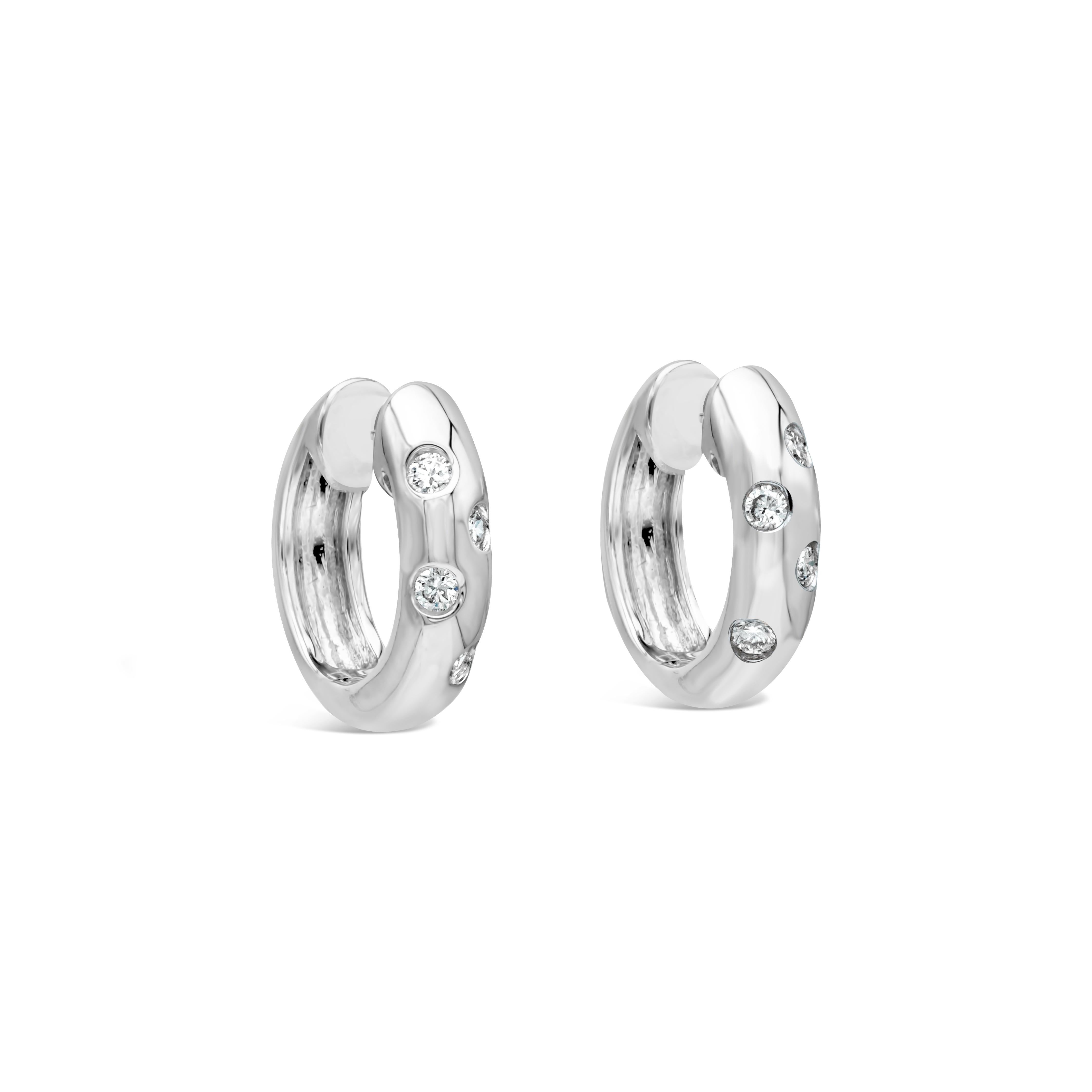 This pair of earrings shows 4 brilliant round diamonds scattered on each earring. Diamonds weigh 0.13 carats total. Aprroximately F-G color, VS-SI clarity. Made in 18k white gold.

Roman Malakov is a custom house, specializing in creating anything