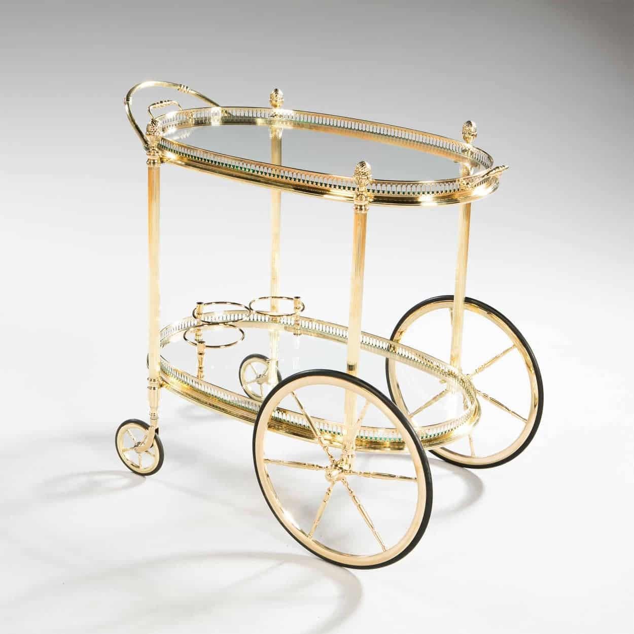 A fabulous and rare Maison Jansen oval polished brass bar cart. 

All of our bar carts are burnished and lacquered to protect the surfaces, we have also replaced the glass tops which often have chips and scratches. They are all taken apart,