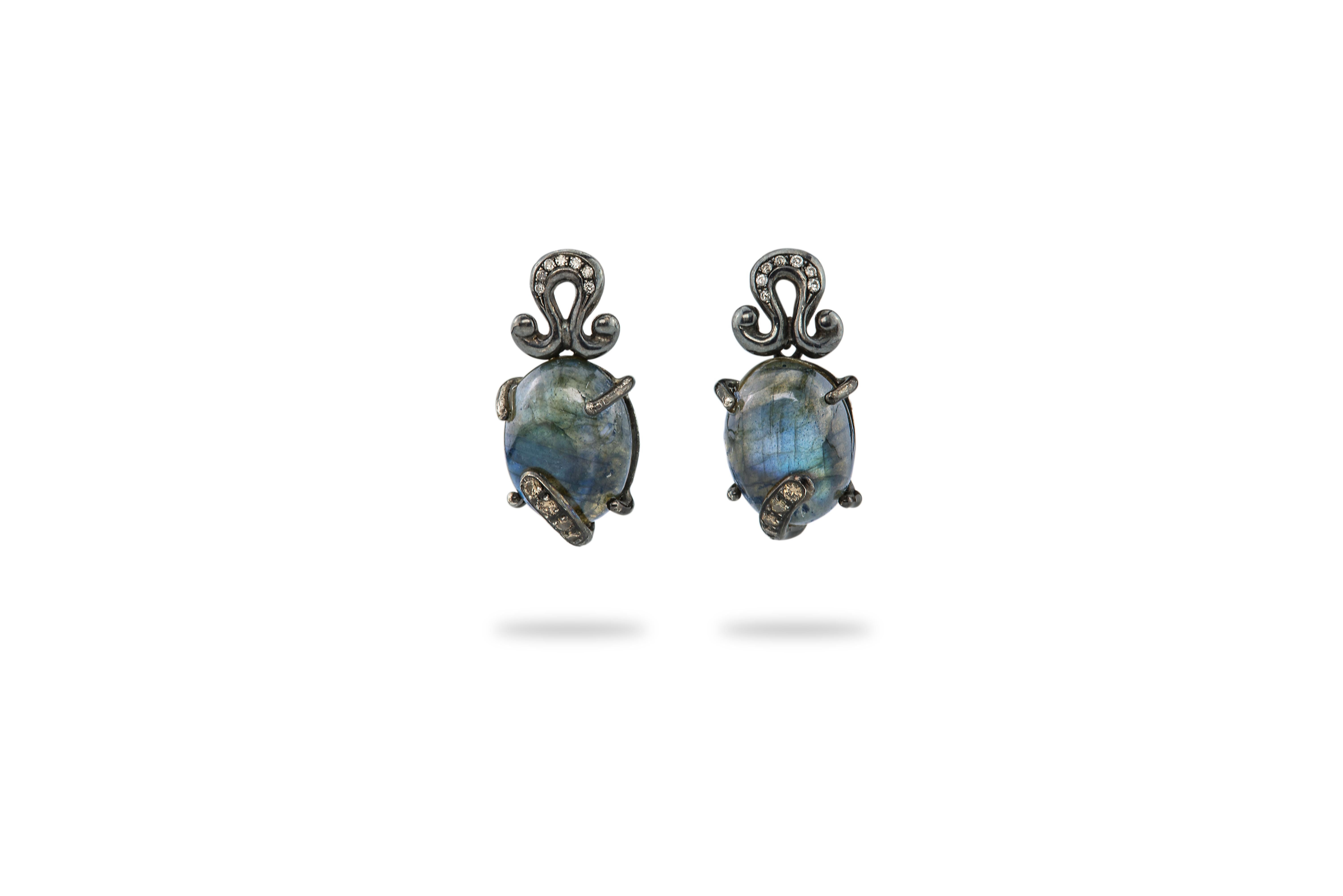 Burnished Silver Labradorite 0.18 Karat Grey Diamonds Dangle DesignEarrings
handcrafted in sterling silver, labradorite and grey diamonds these earrings belong to the Rock collection made with burnished silver and softened by colored stones and are