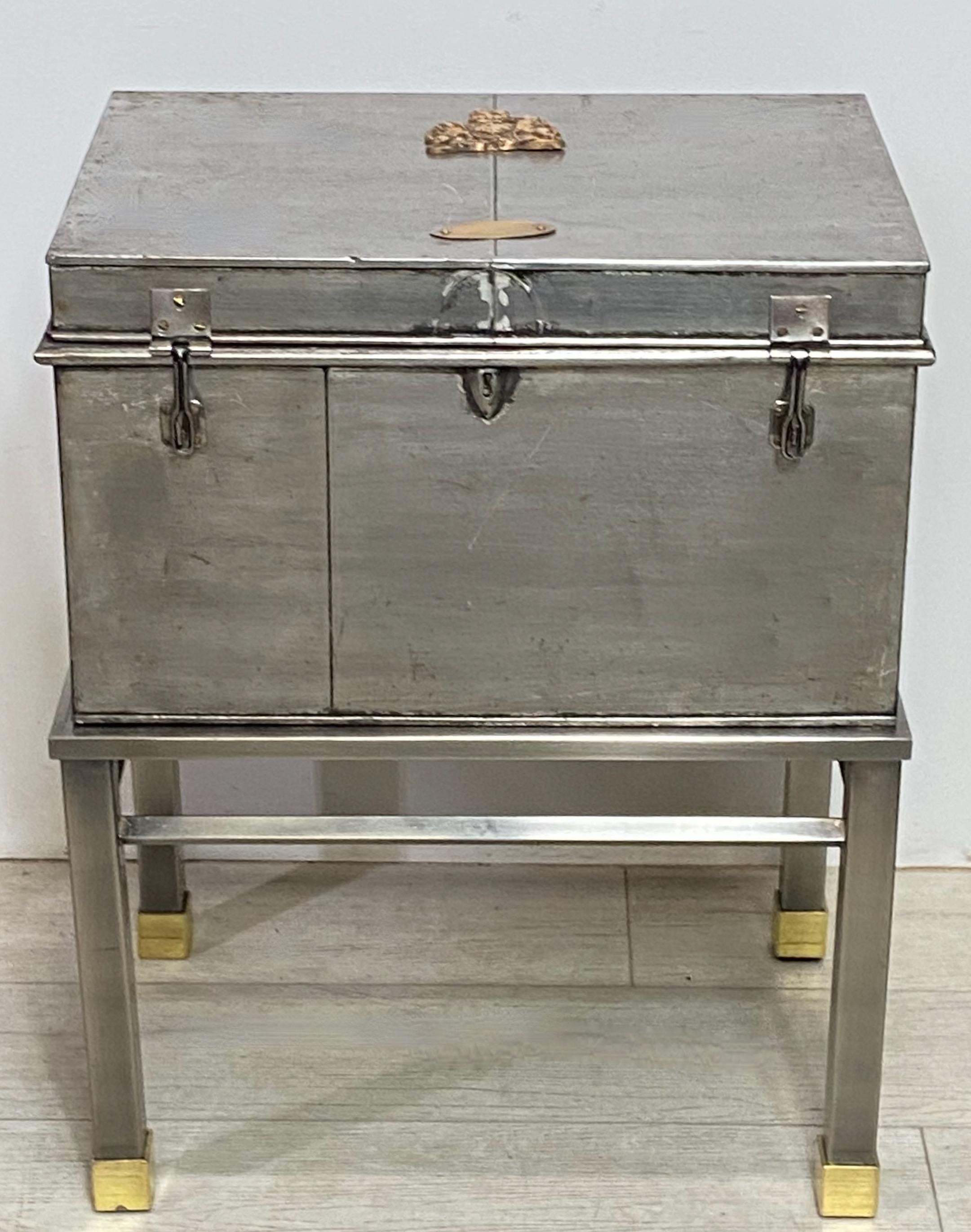 An unusual burnished steel and brass box on custom made steel and brass stand.
England, 19th century.

 