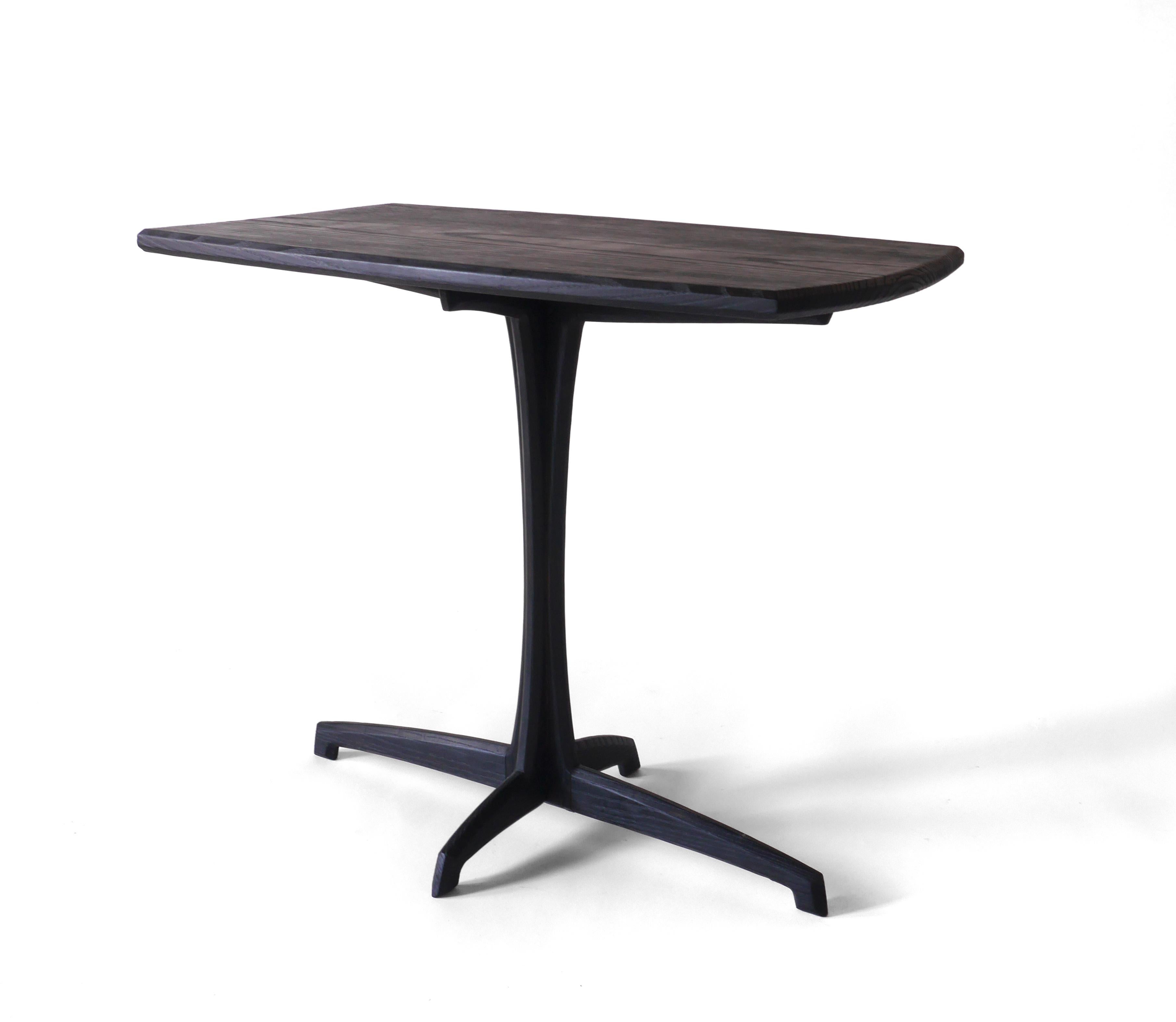 This elegant Plume Side Table is made out of solid white ash hardwood that has been charred black with fire, scrubbed to remove the ash, and sealed with a hand rubbed oil finish. This process leaves a black that’s deeper and has more character than