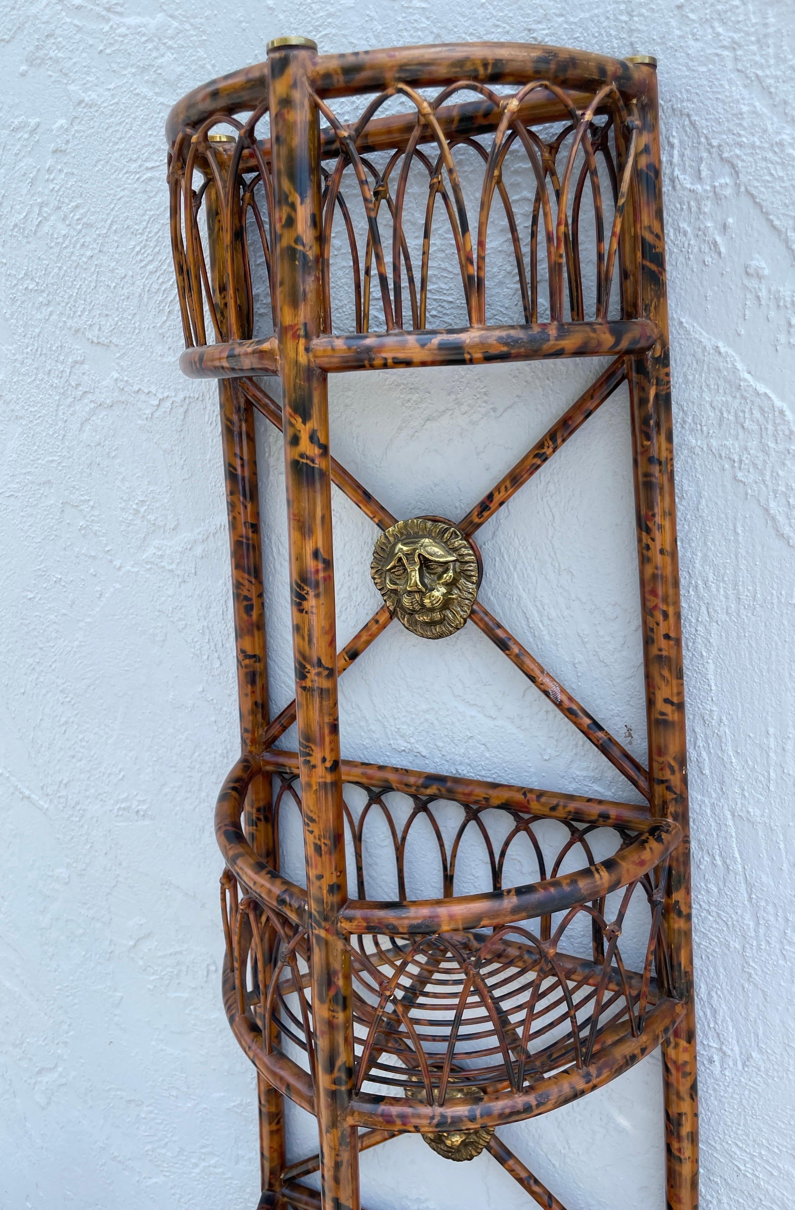 Very unique and versatile Burnt Bamboo demilune three shelf etagere. Very well made with three brass lion head medallions on back section. Will work almost anywhere.