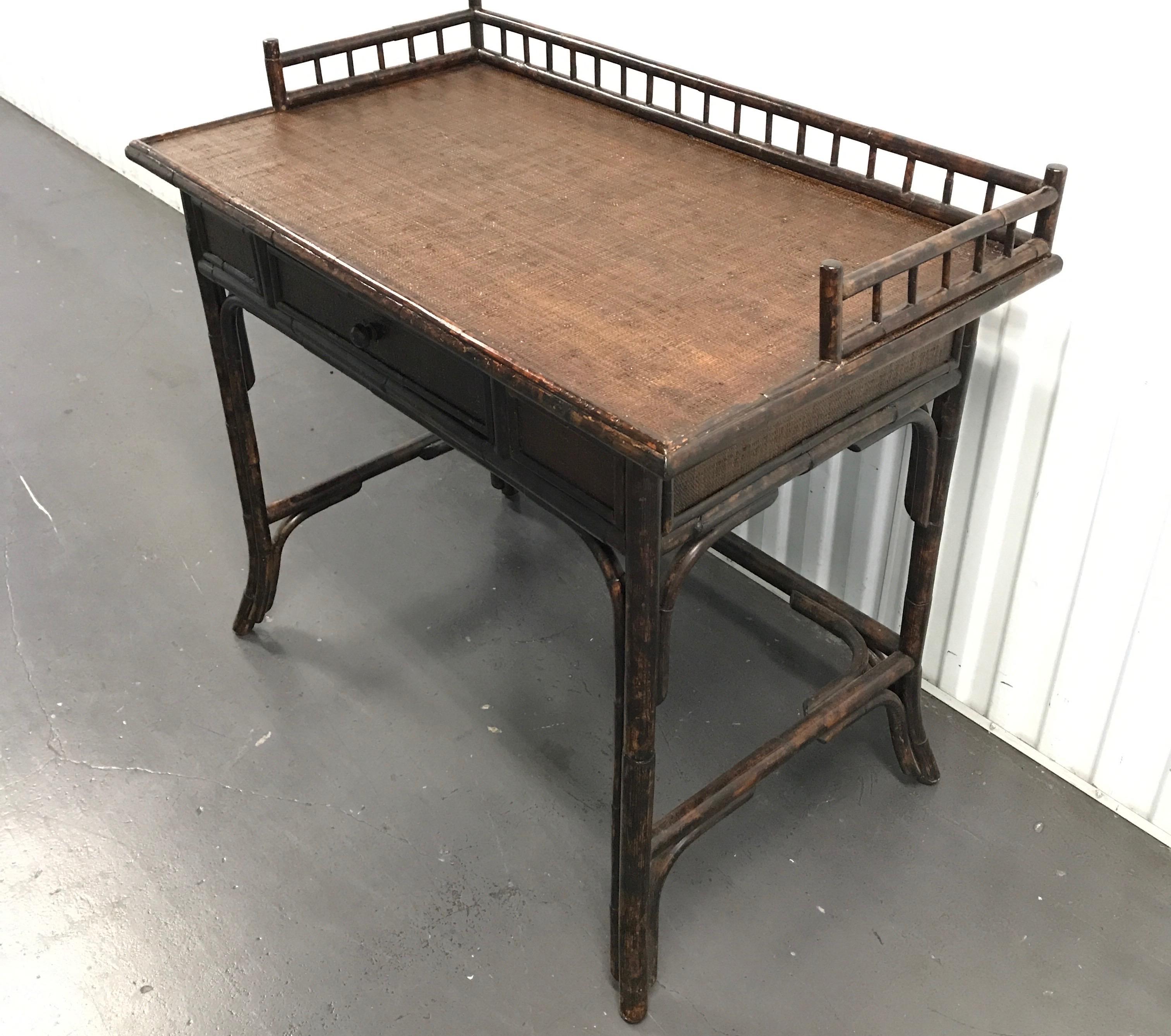Burnt bamboo galleried desk with grass cloth top writing surface. Would also make a lovely vanity table.