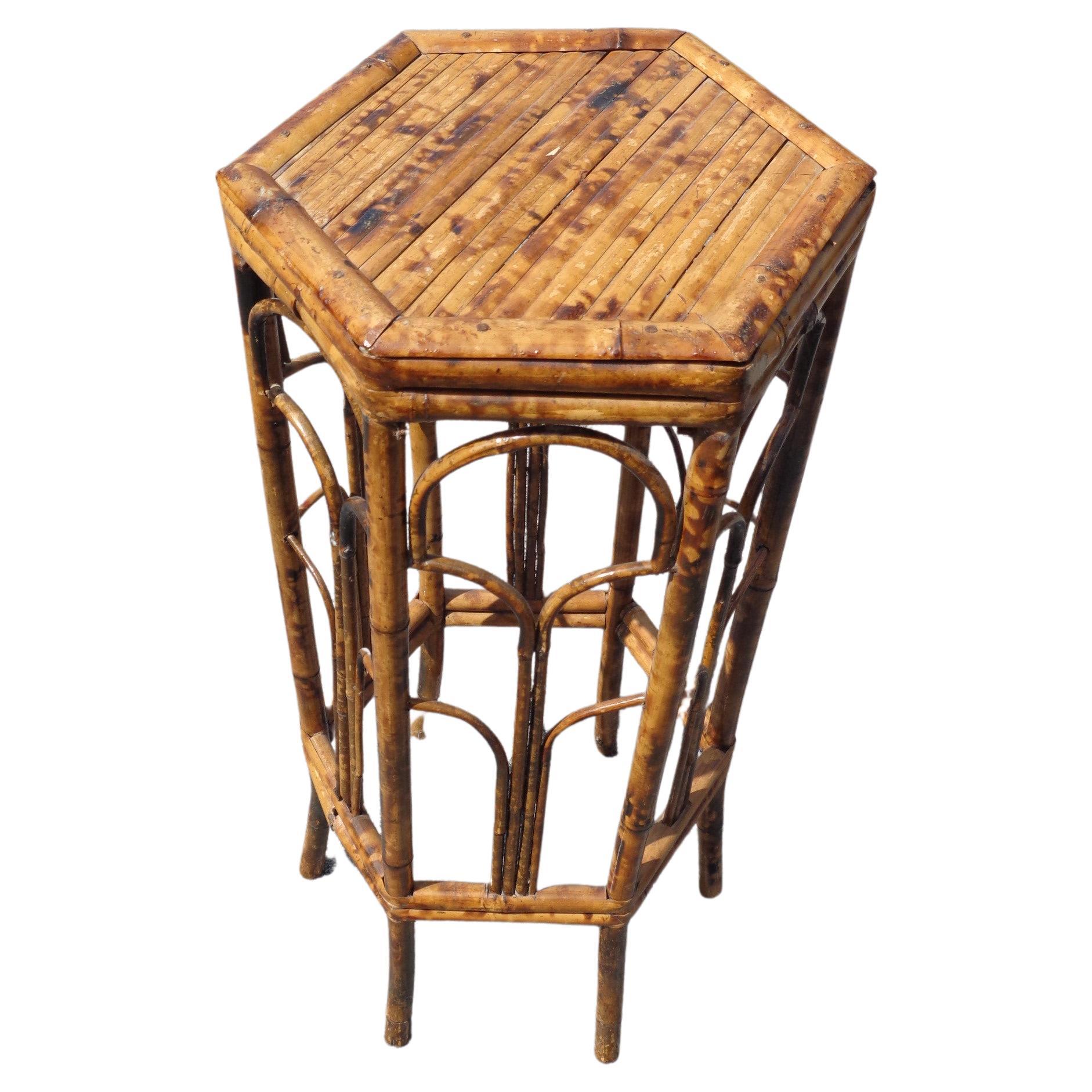Burnt tortoise shell bamboo rattan hexagonal plant stand pedestal table in very nice original rich color. Circa 1970's. Measures 30