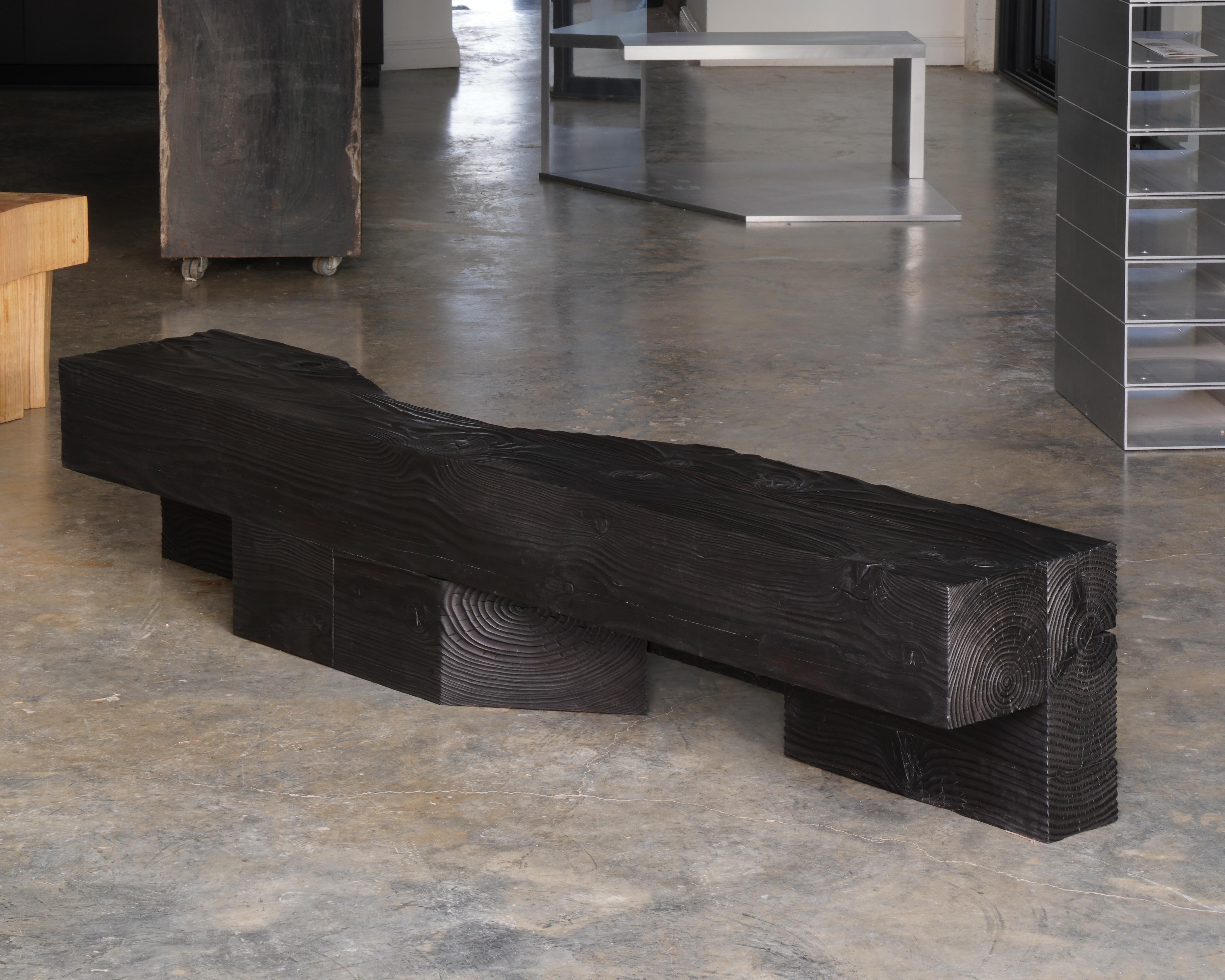 The Slide series is inspired by both the brutalist and geometric form of urban furniture typologies. This piece, designed by the duo Heim+Viladrich, consists of a bench crafted from burnt, brushed, and waxed Douglas fir. This surface treatment