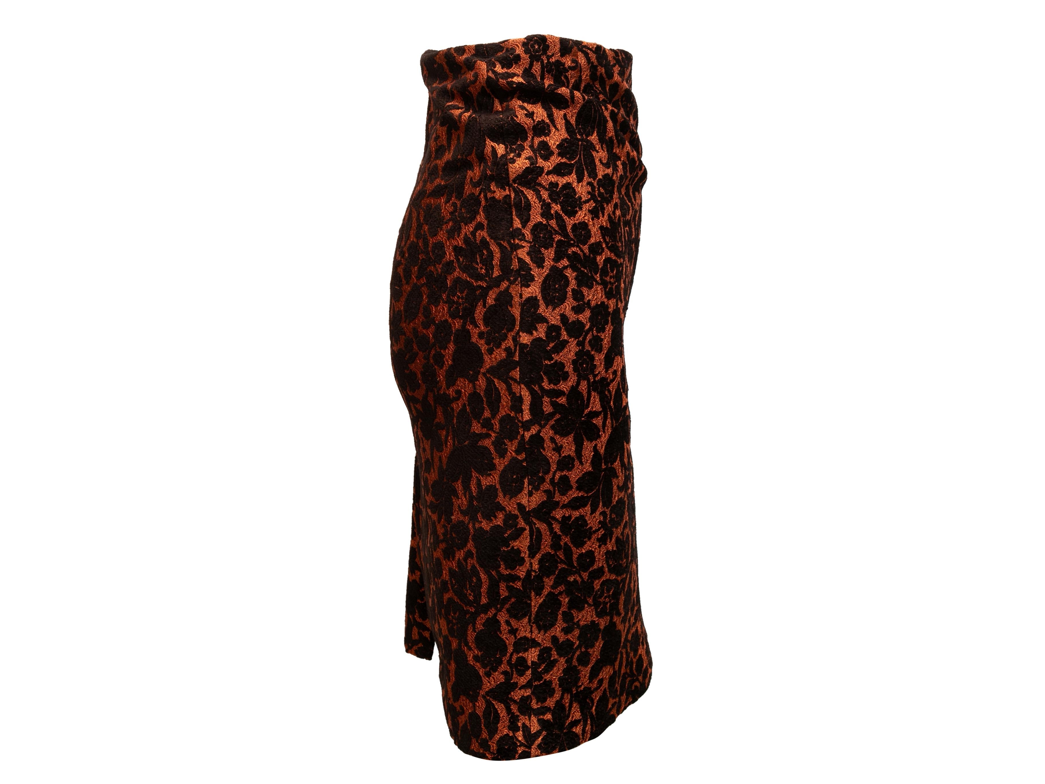 Burnt orange and black brocade knee-length pencil skirt by Carolina Herrera. Zip closure at back. 26