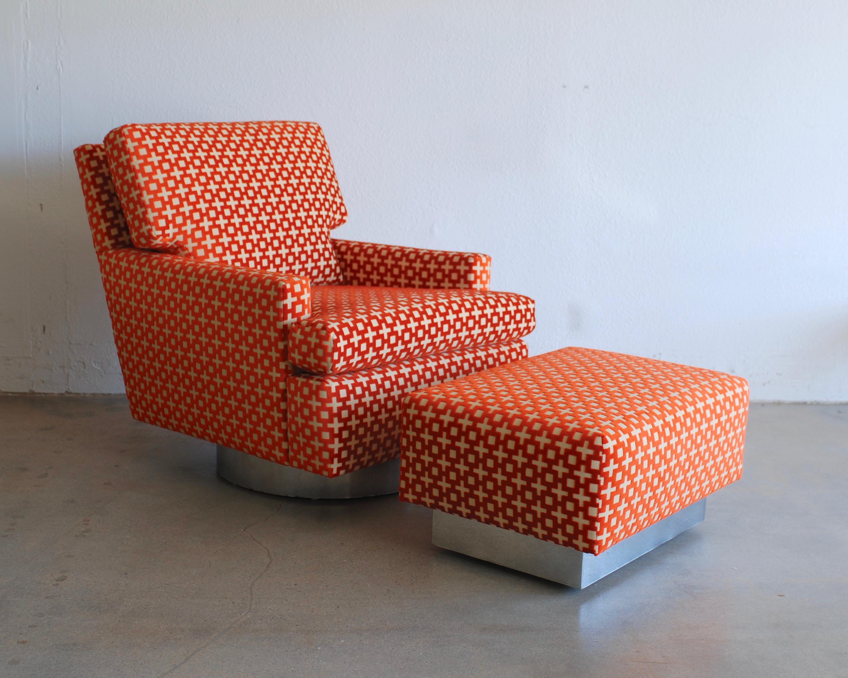 The raised velvet burnt orange geometric patterned fabric on this swivel lounge chair is reminiscent of David Hick's style. The color and geometric of the fabric really pops against the chrome swivel base of the chair. The ottoman base has hidden