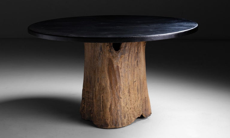 Burnt pine dining table.

Made in England.

Charred pine top on dugout beech trunk base.

Measures: 50.75”diameter x 29”height.