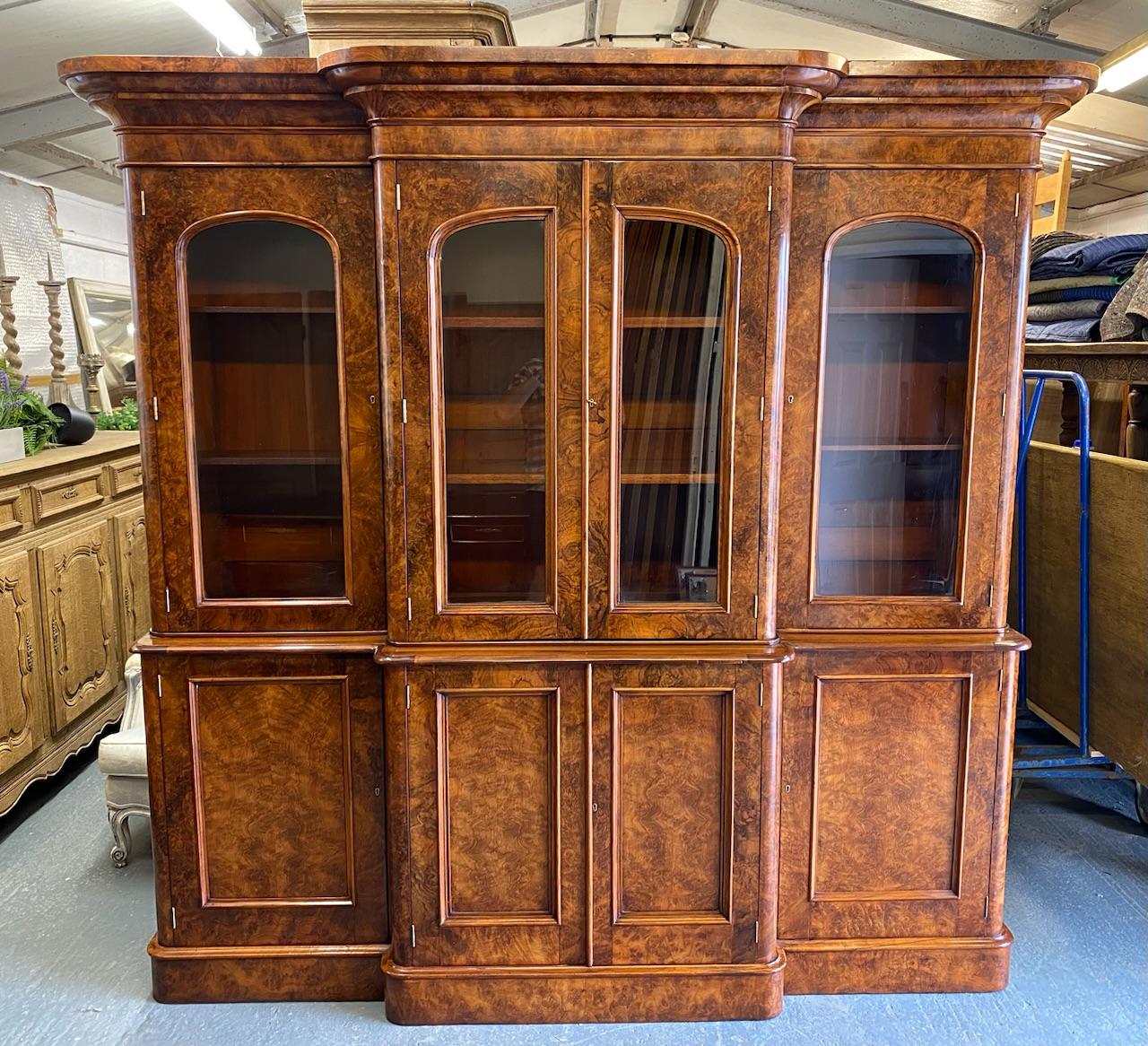 A lovely Burr Walnut Library Bookcase, breakfront and round cornered in form and dating to the mid Victorian period. A very good quality piece and typical of the Victorian craftmanship. All the doors are lockable, key present. There are 2 shelves in