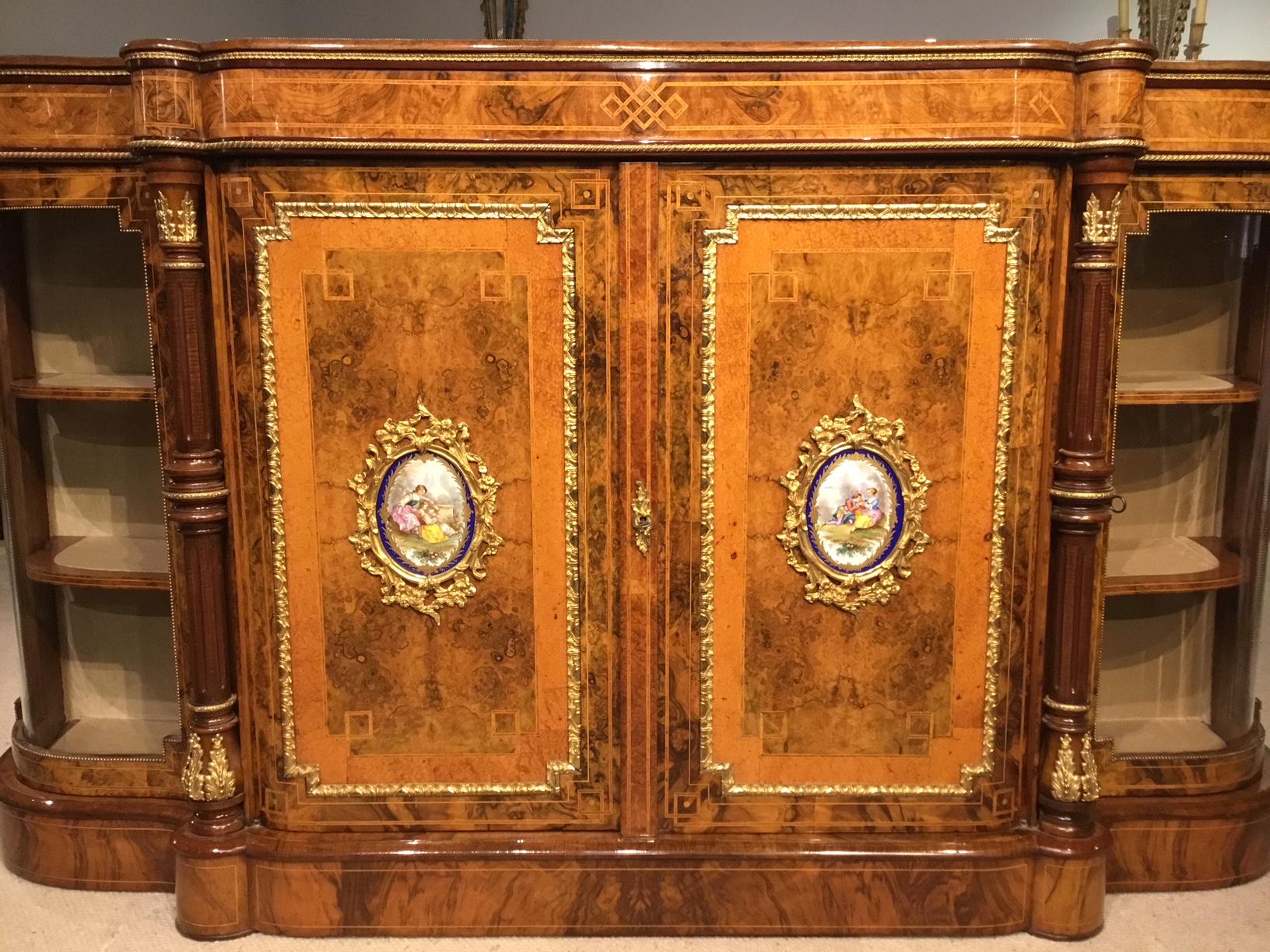 A fine quality burr walnut, amboyna and ormolu mounted Victorian Period credenza. Having a rectangular top with serpentine ends veneered in beautifully figured burr walnut with kingwood banding and stained sycamore roundels. The front with a burr